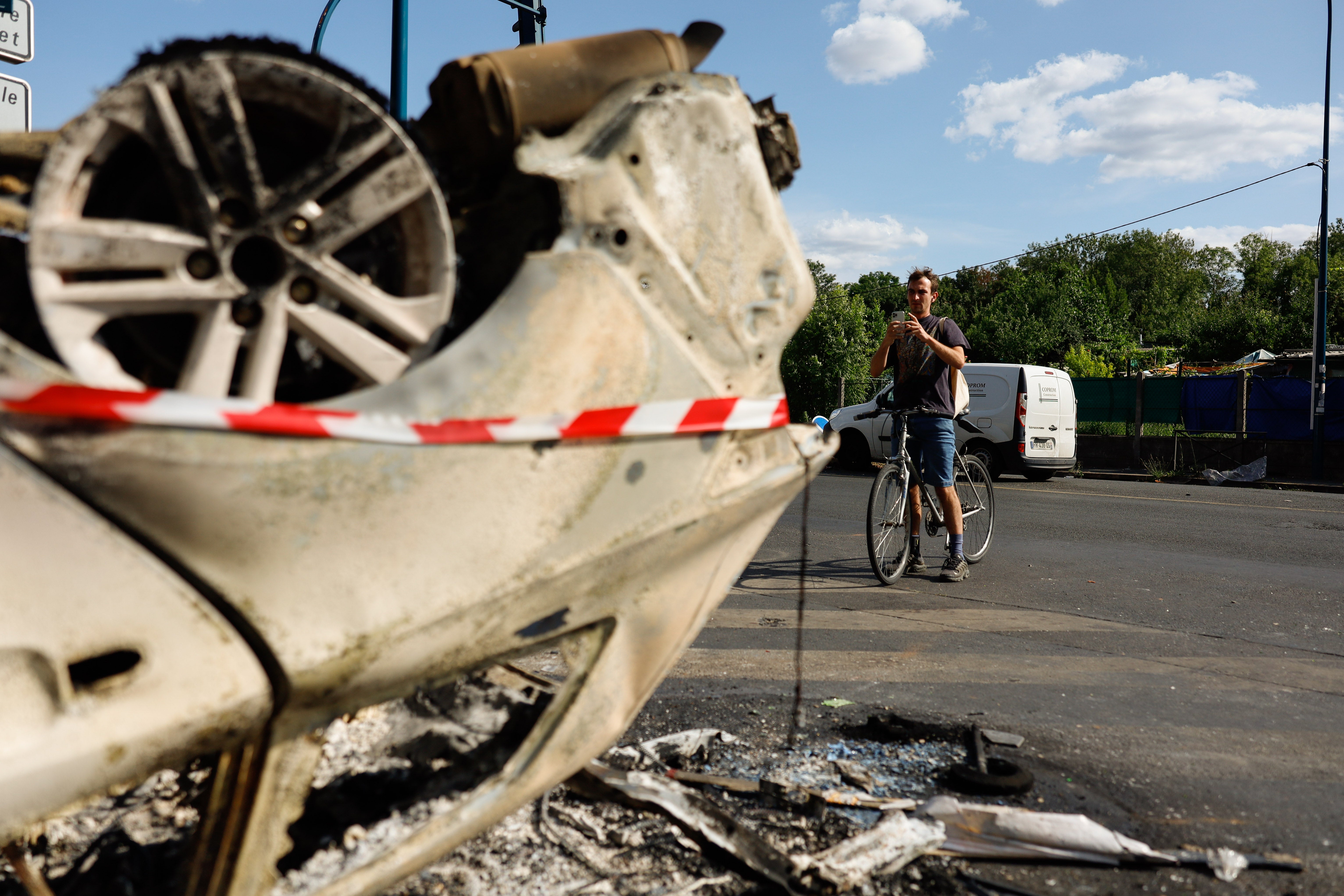 A car was damaged during night clashes between protesters and police in Aubervilliers, Paris