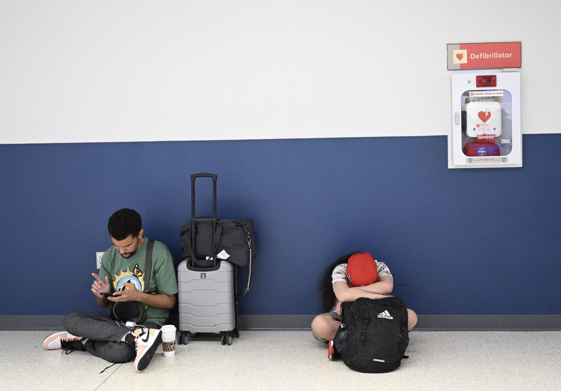 Passengers wait at the Newark Liberty International Airport as more than 2000 flights were canceled due to the nationwide storm in New Jersey this past week