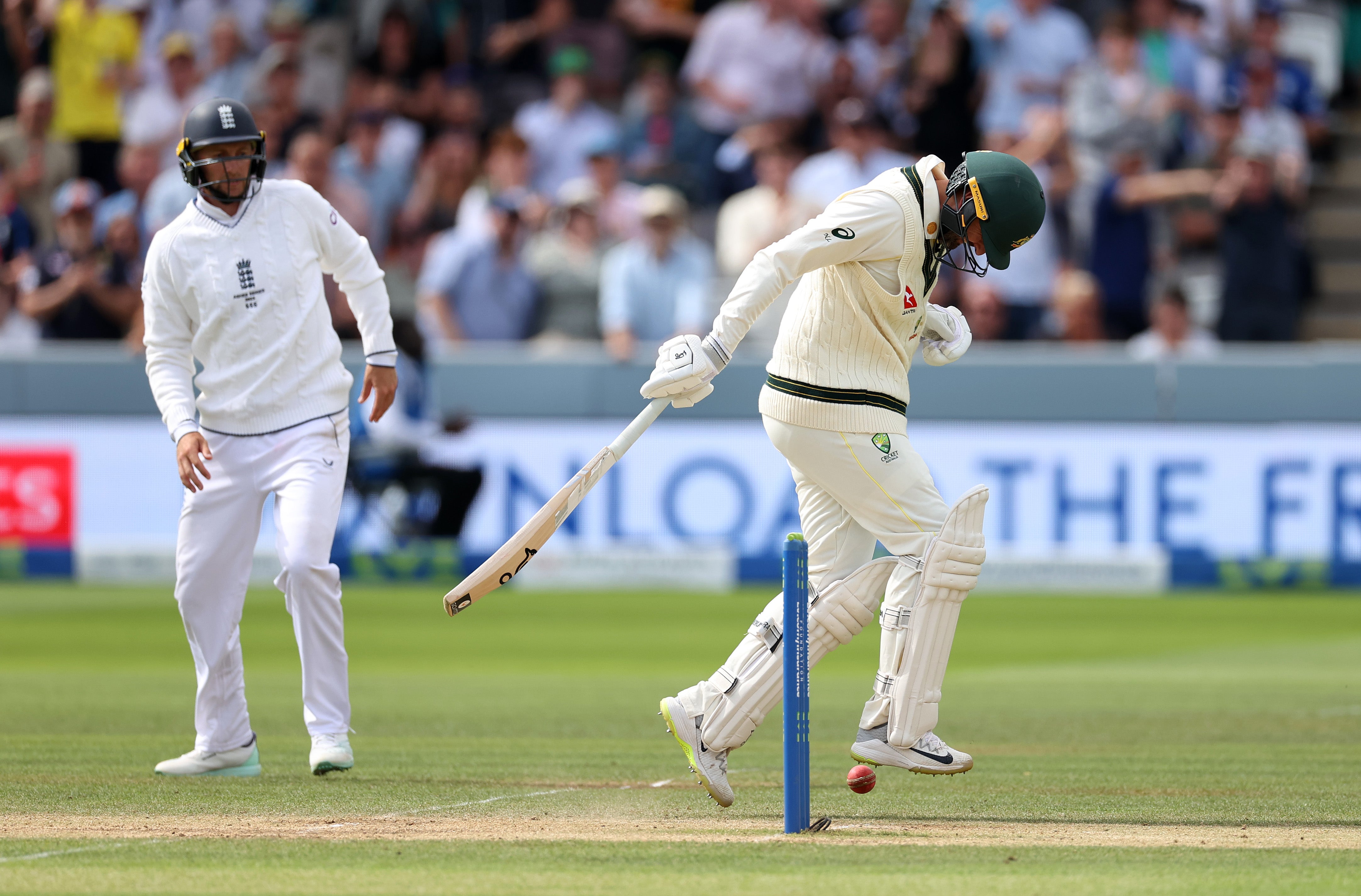 Nathan Lyon (right) took to the field despite carrying a significant injury sustained on the second day