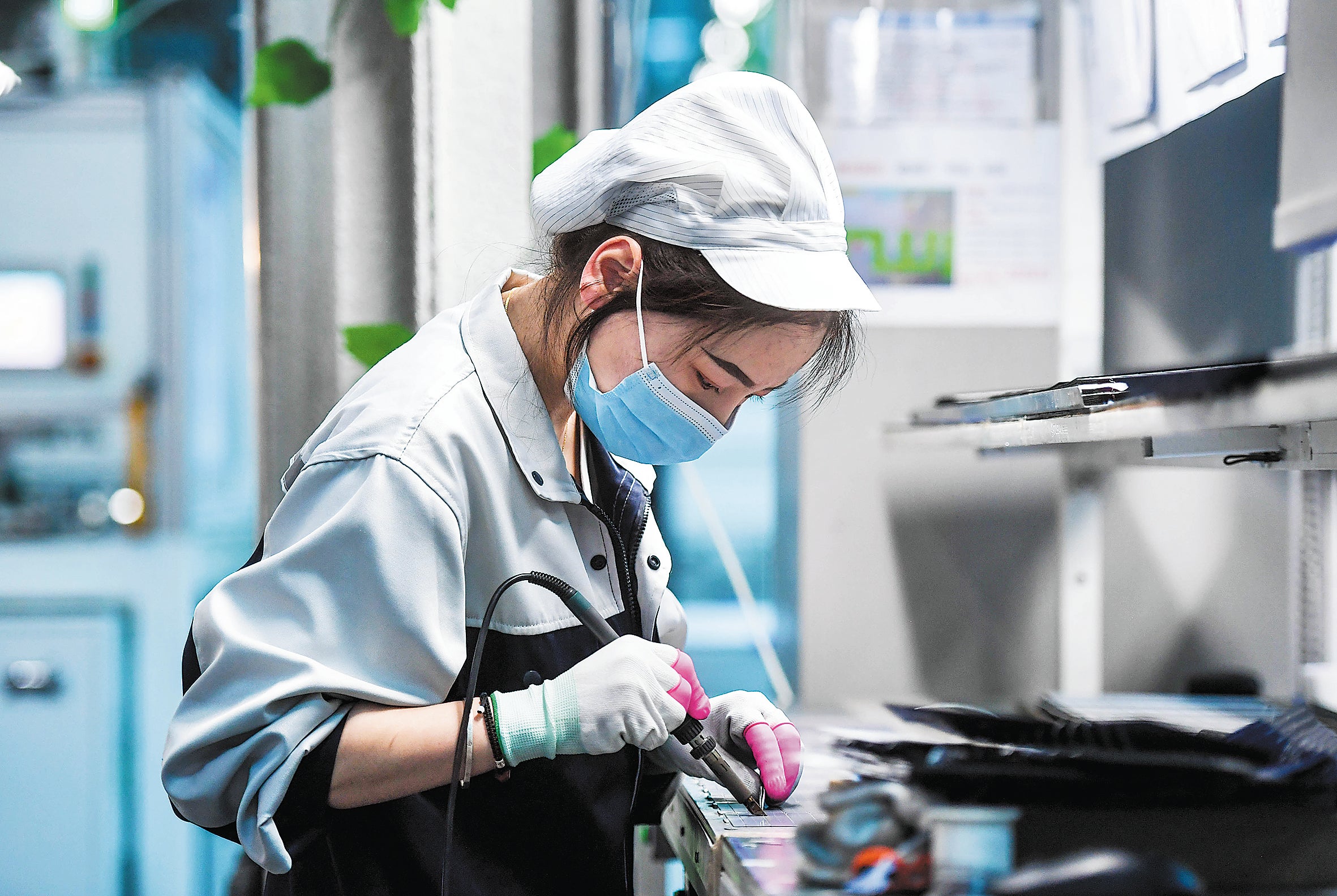 An employee works on the photovoltaic production line of a tech company in the Inner Mongolia autonomous region