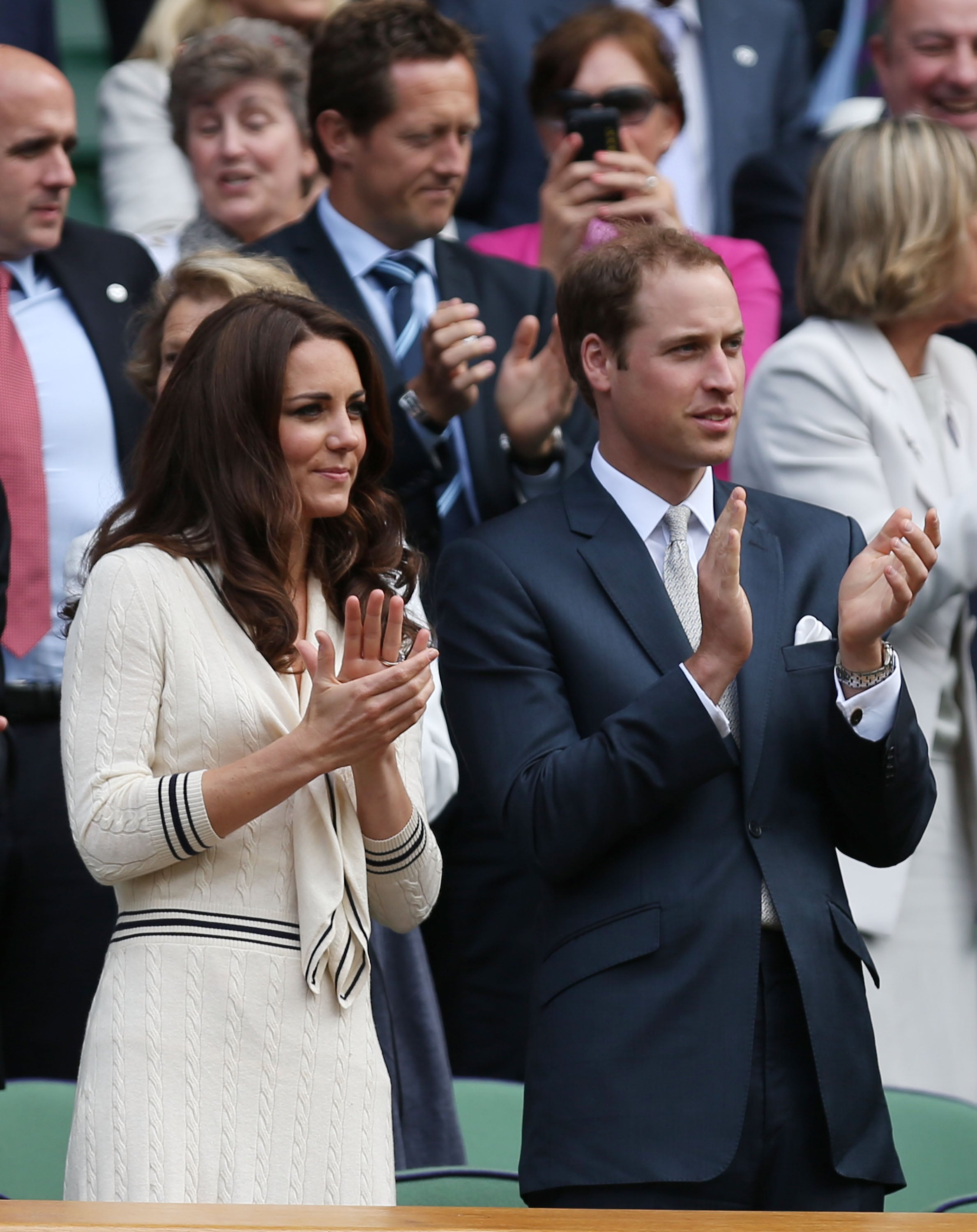 Catherine, Duchess of Cambridge and Prince William, Duke of Cambridge applaud from their seats in the Royal Box on Centre Court during day nine of the Wimbledon Lawn Tennis Championships at the All England Lawn Tennis and Croquet Club on July 4, 2012