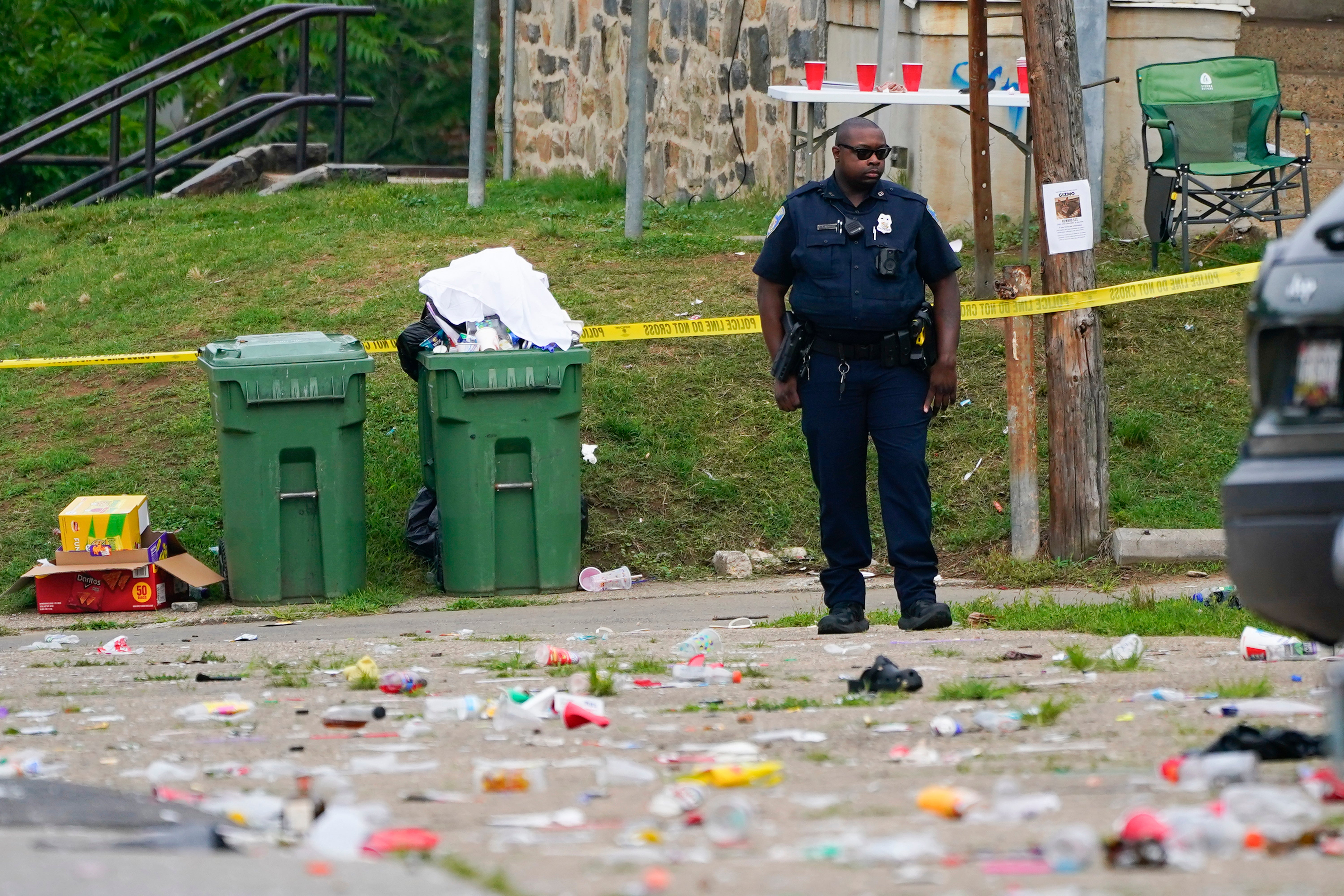 A police officer stands in the area of the mass shooting in Baltimore