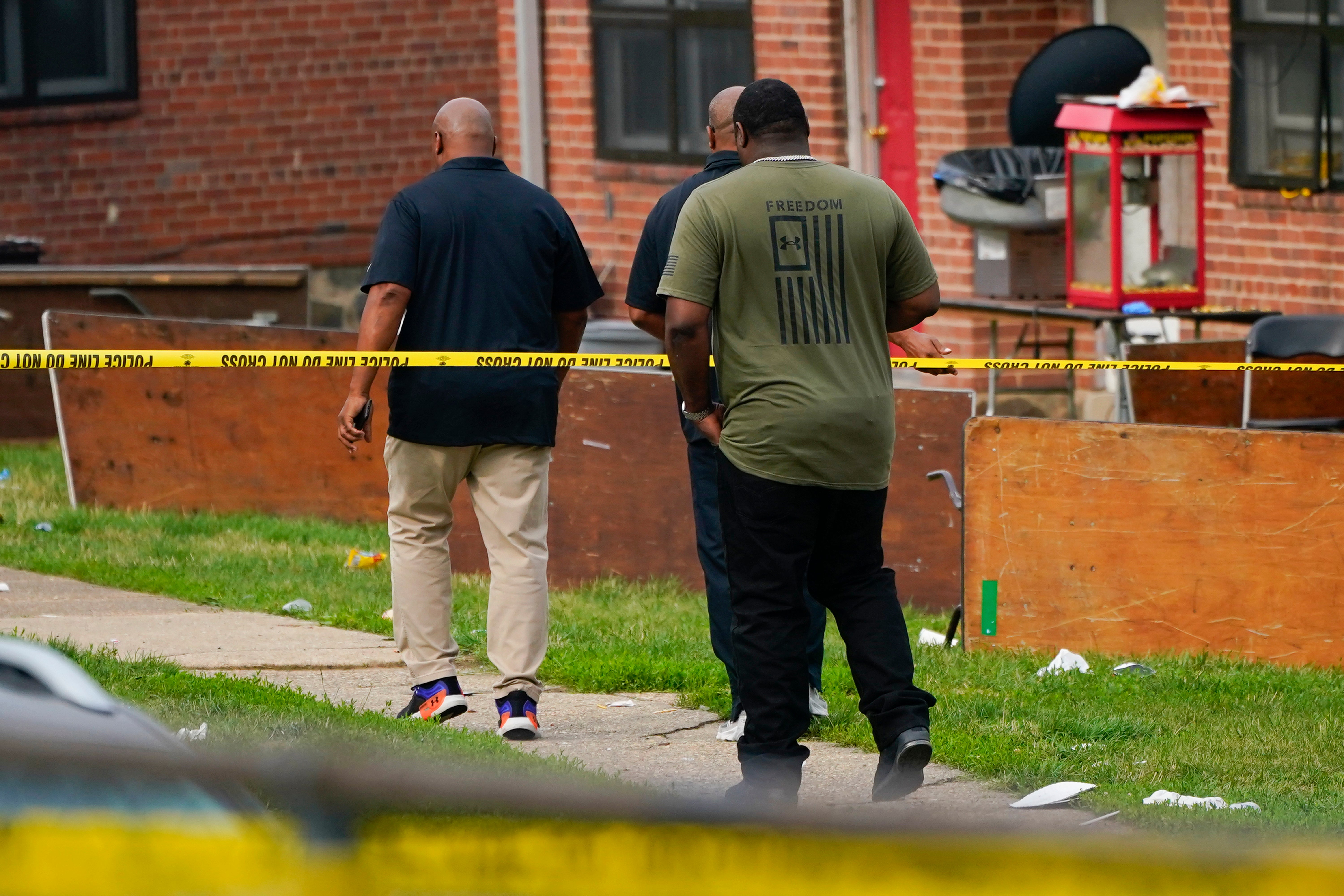 Members of Baltimore community walk through crime scene