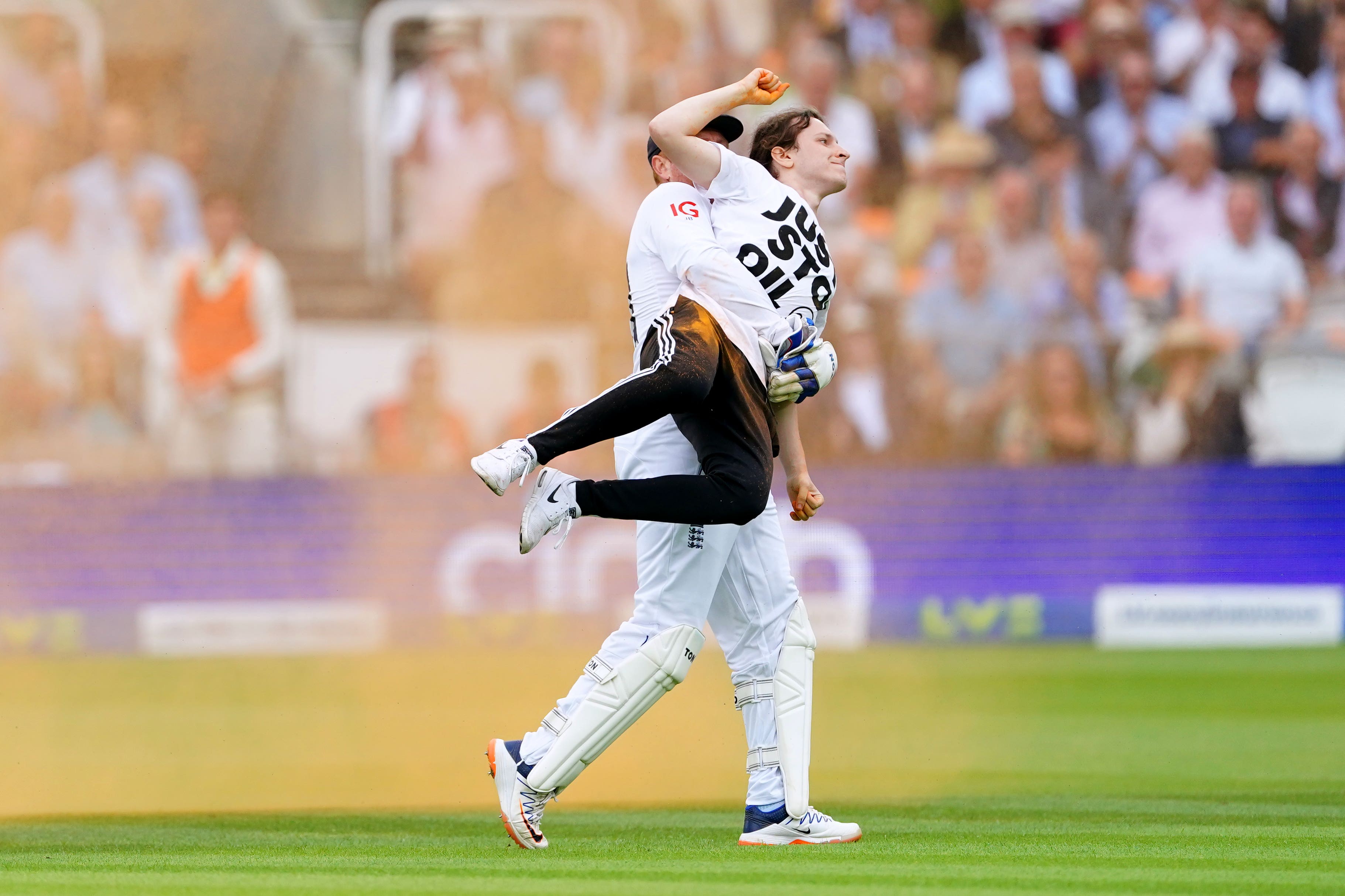 England’s Jonny Bairstow carries a Just Stop Oil protester off the pitch at Lord’s (Mike Egerton/PA).