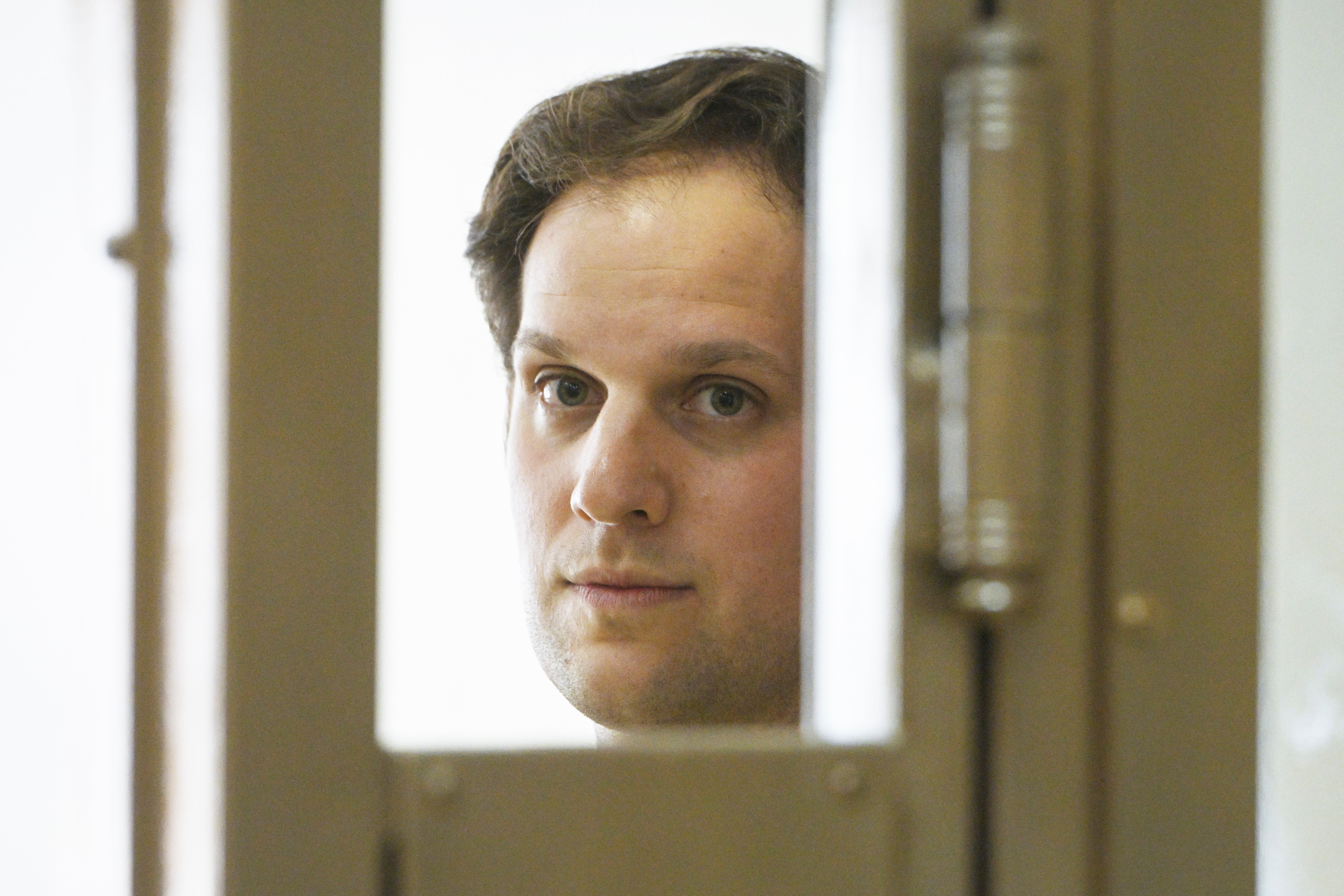 Wall Street Journal reporter Evan Gershkovich stands in a glass cage in a courtroom at the Moscow City Court in Moscow, on 22 June