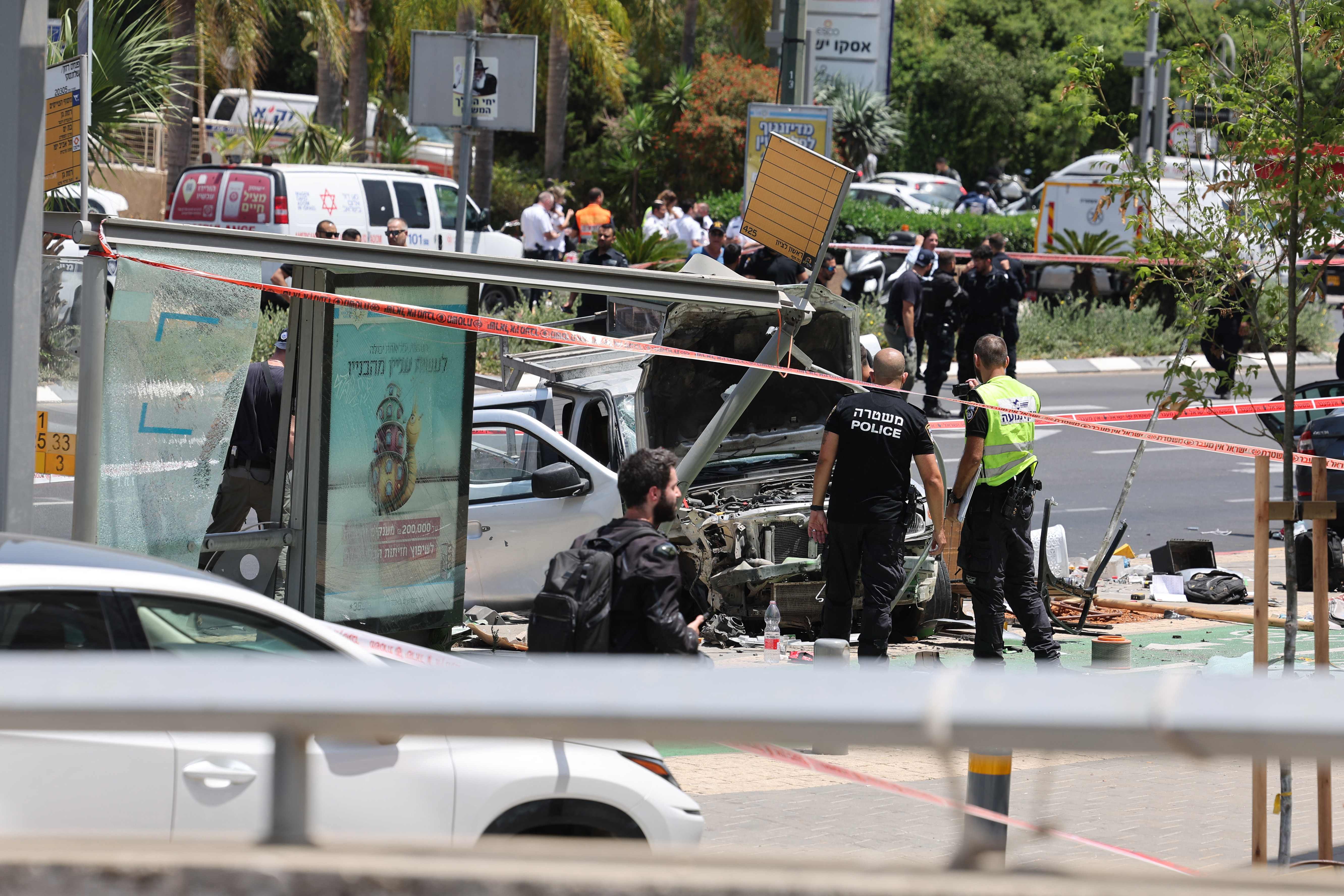 Israeli security and emergency personnel work at the site of a reported car ramming attack in Tel Avi