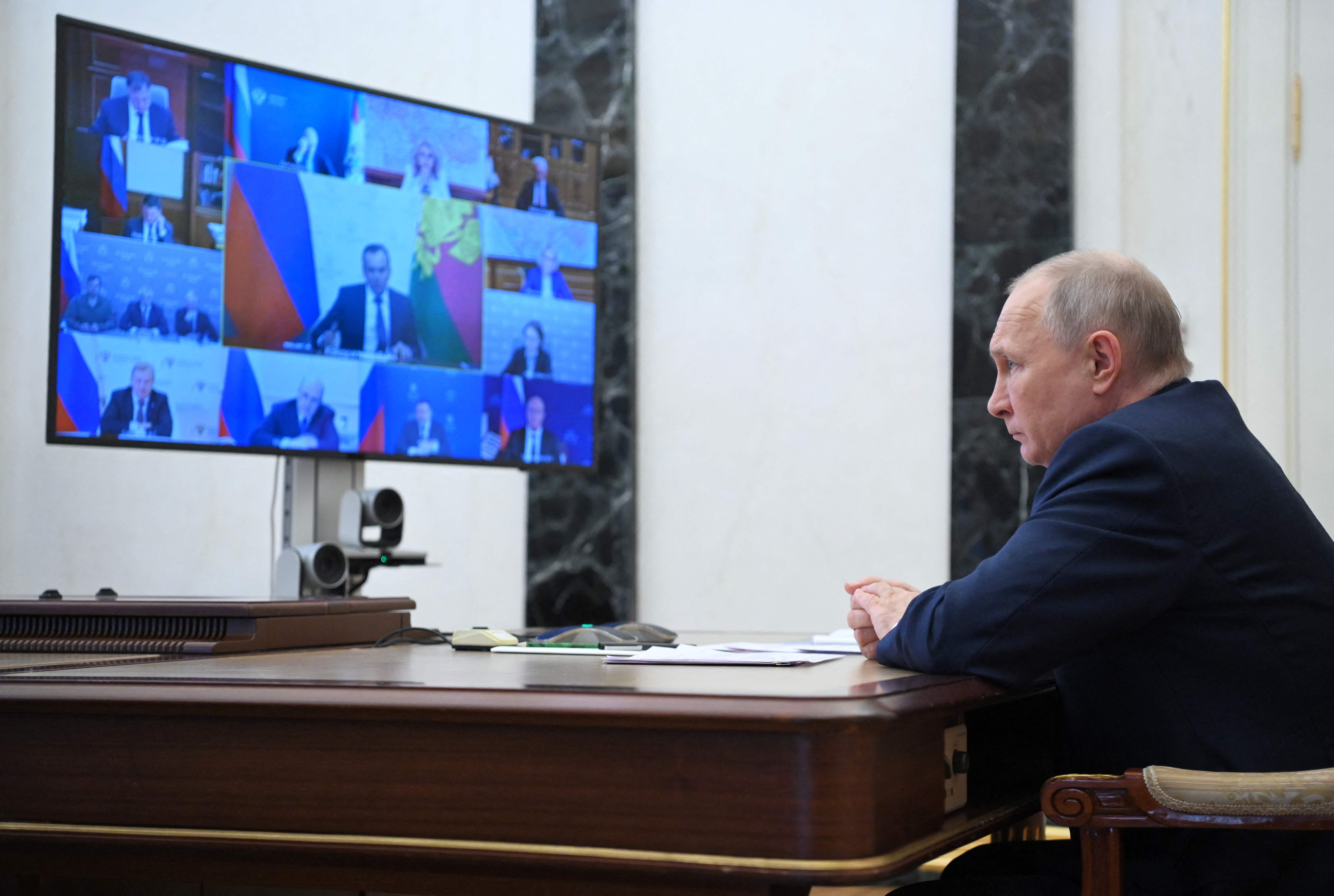 Putin joins a video conference from the Kremlin