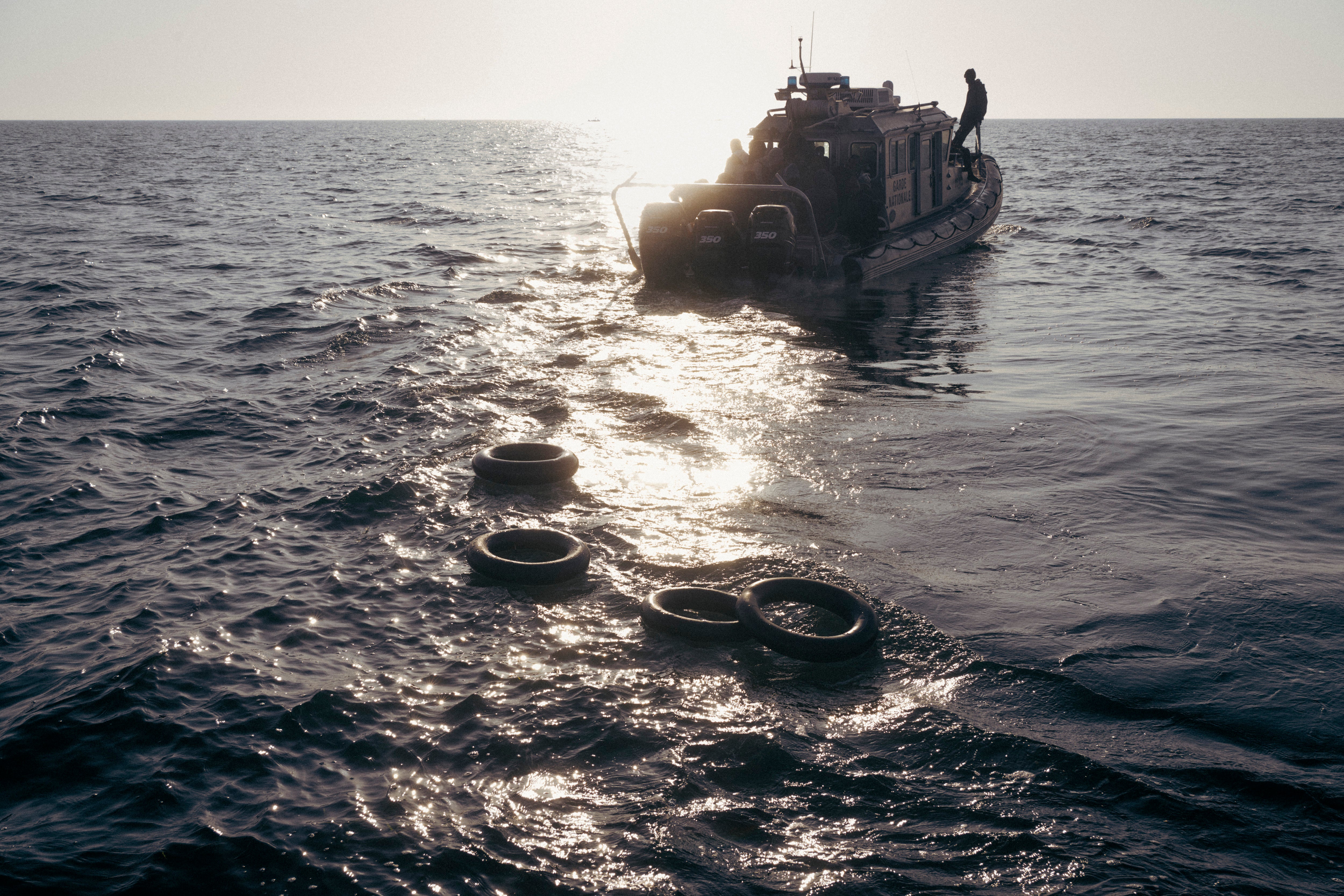 Lifebuoys float near the area where the Tunisian Coast Guard sunk a migrant boat to prevent smugglers from reusing it