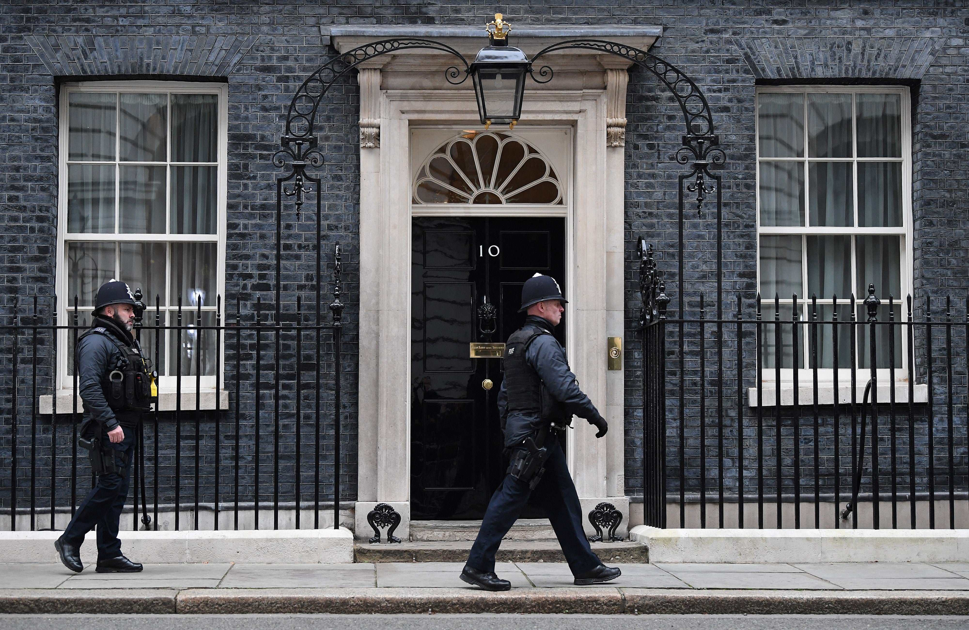 A police officer walks past the door to 10 Downing Street, the official residence of Britain’s prime minister, in London on 25 January 2022