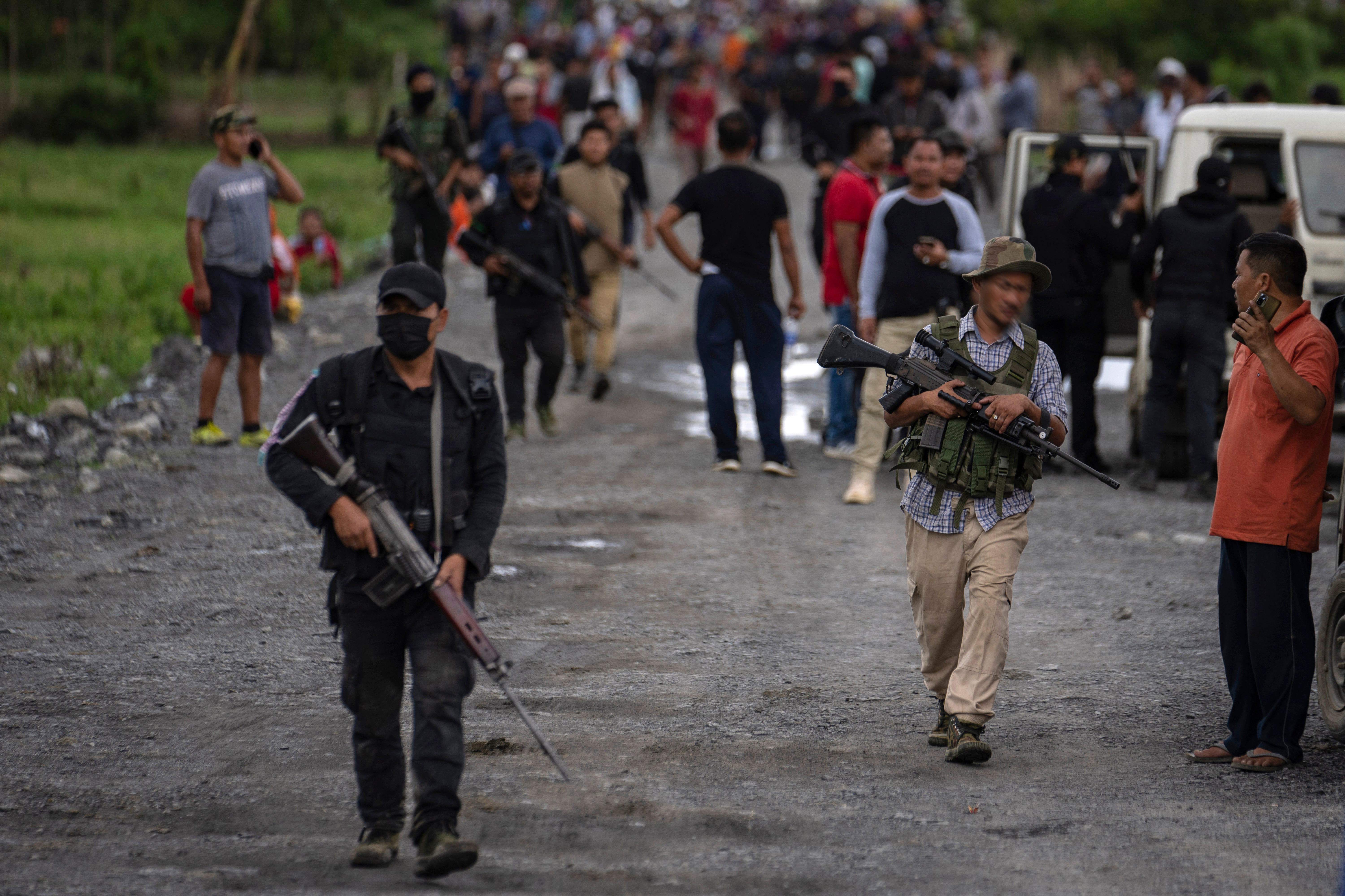 Armed members of the Meitei community carry automatic weapons in Manipur during the deadly conflict between two ethnic communities that have launched brutal attacks against one another