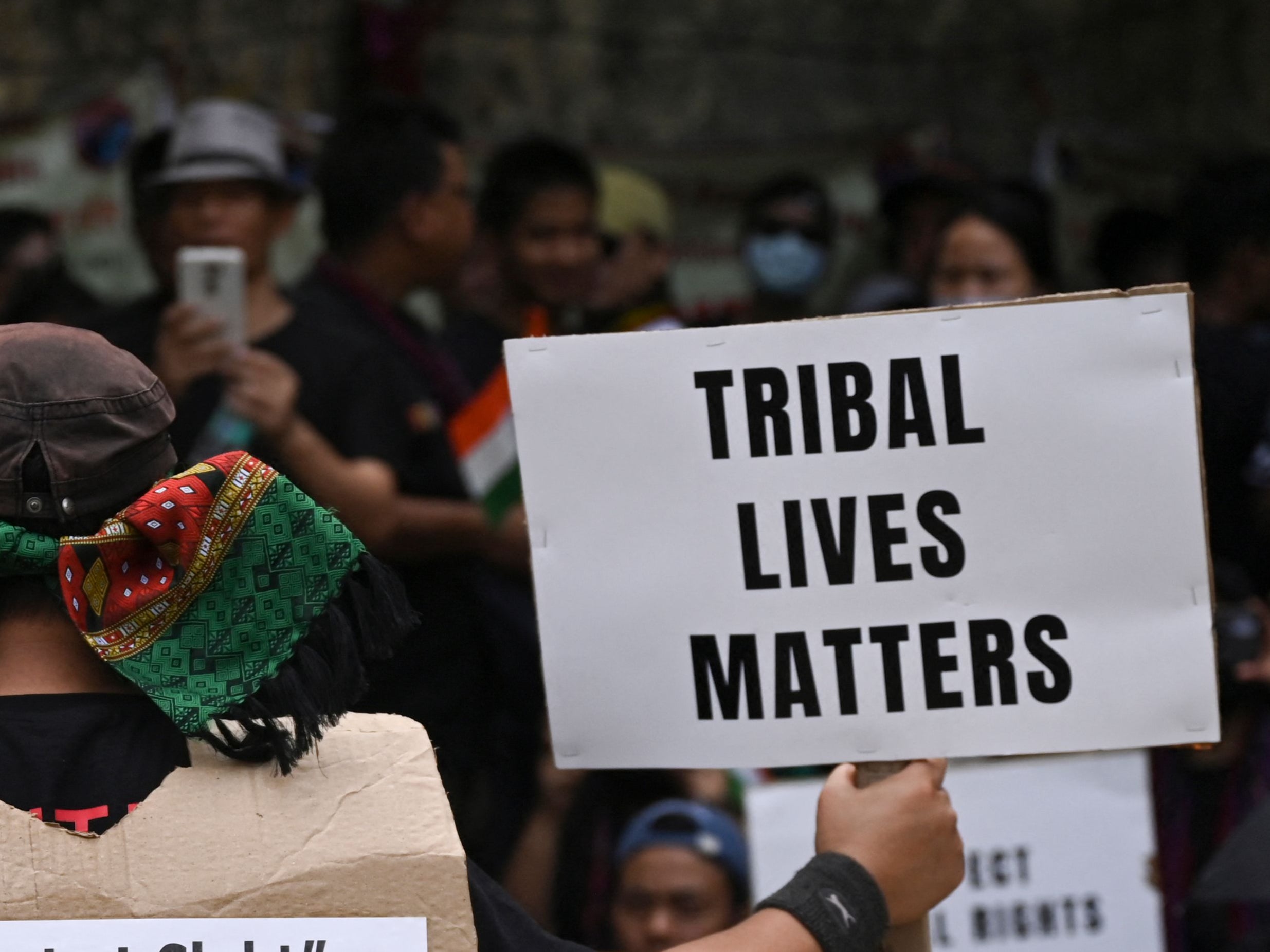 Activists of the All Tribal Students Union Manipur (ATSUM) hold placards during a protest in New Delhi on 31 May 2023