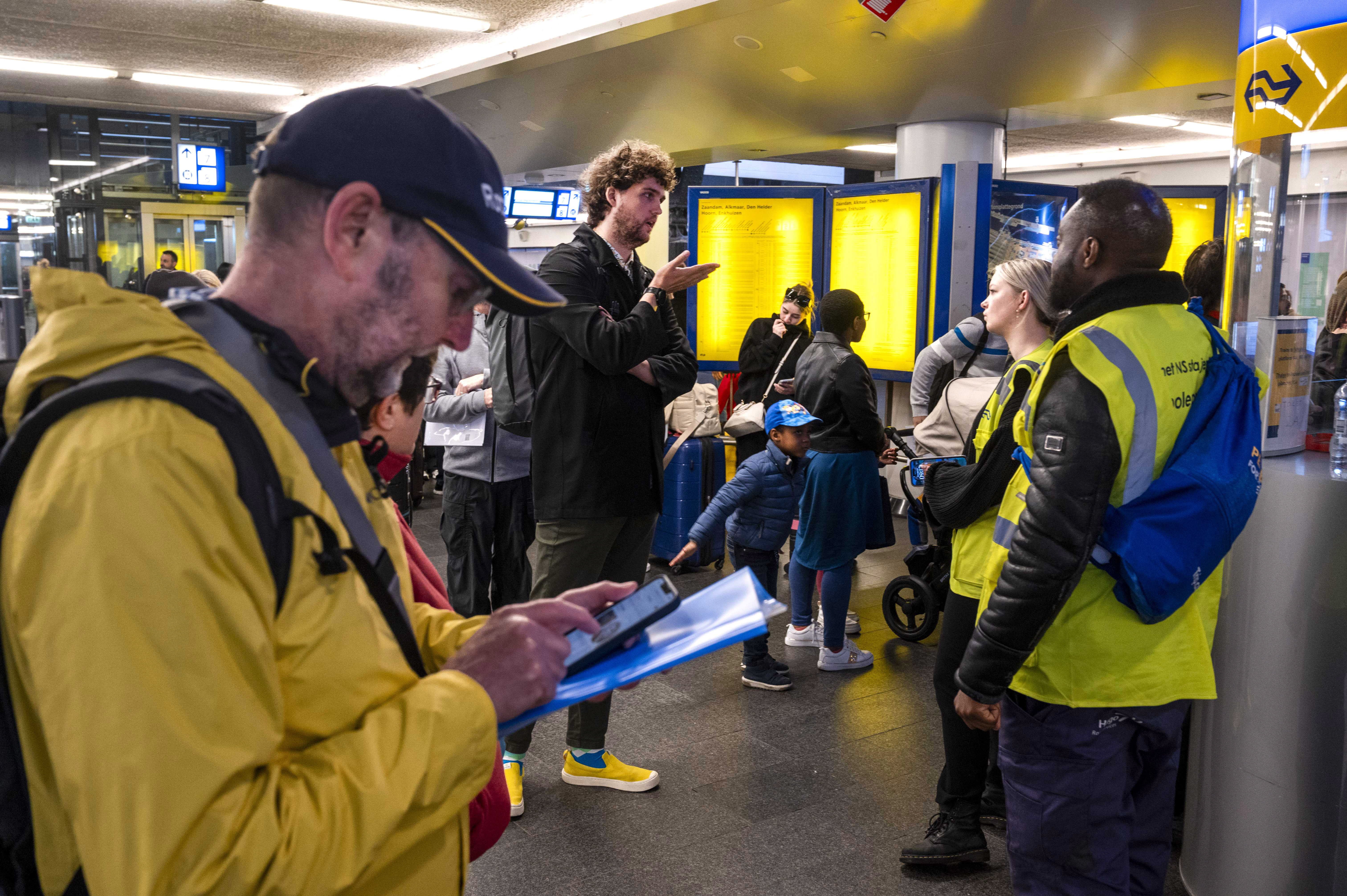 Travellers wait at the Central Station in Amsterdam, The Netherlands