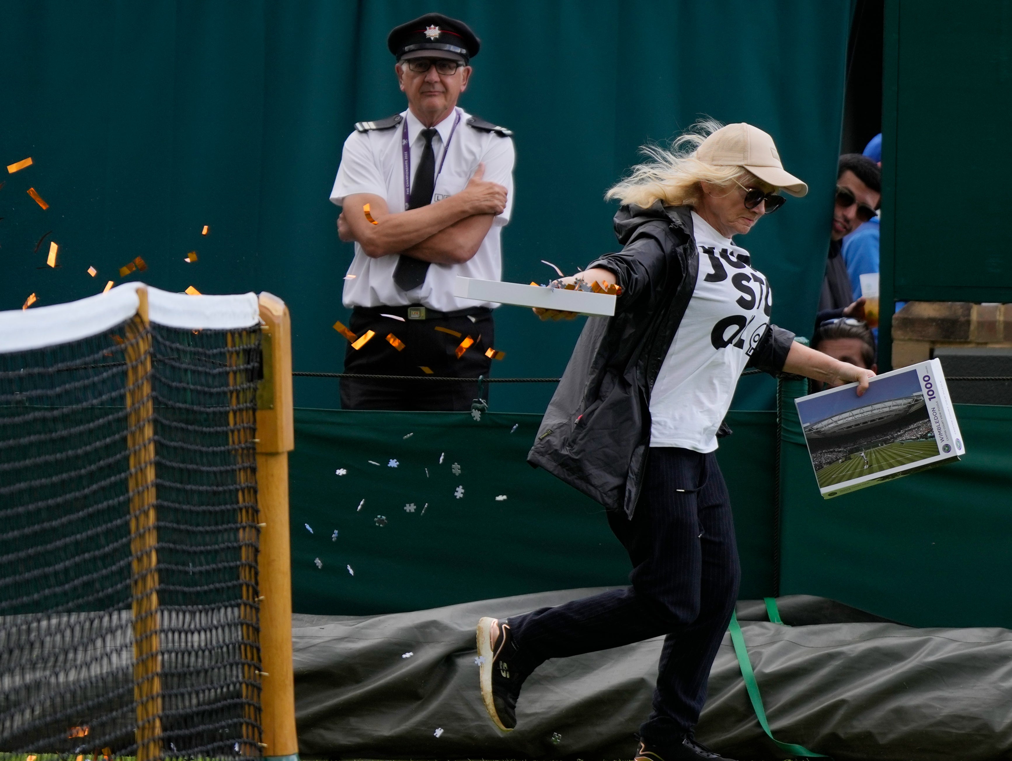 A protester showered environmentally-friendly confetti and jigsaw pieces onto the court