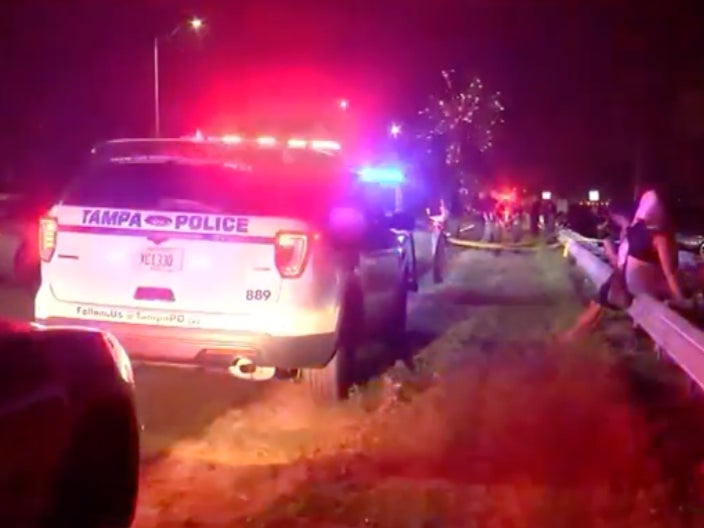 Police cars arrive at the scene of a 4 July, 2023, shooting in Tampa