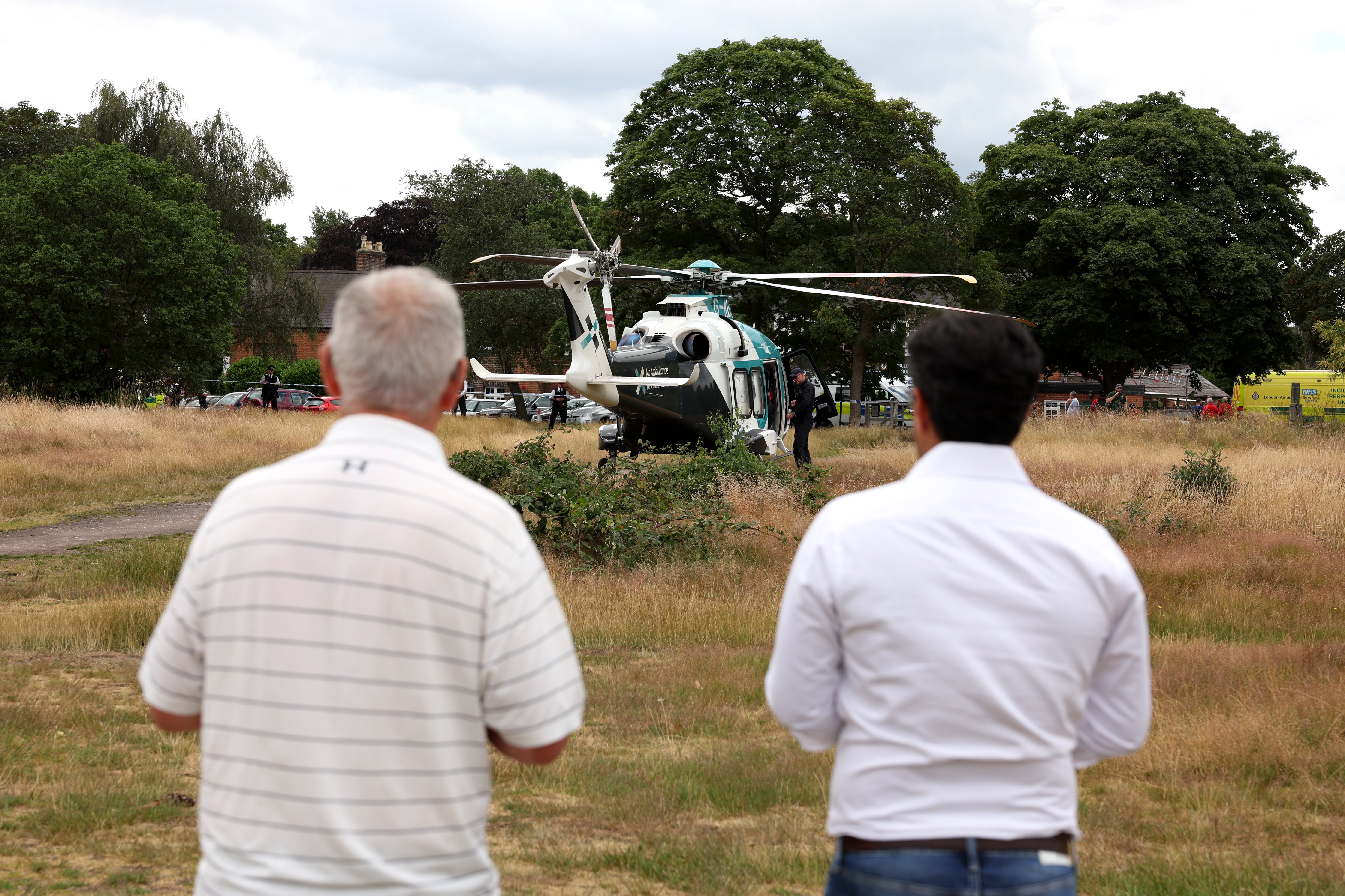 An air ambulance lands on Wimbledon Common as police and emergency services attended the scene of the car crash at the school