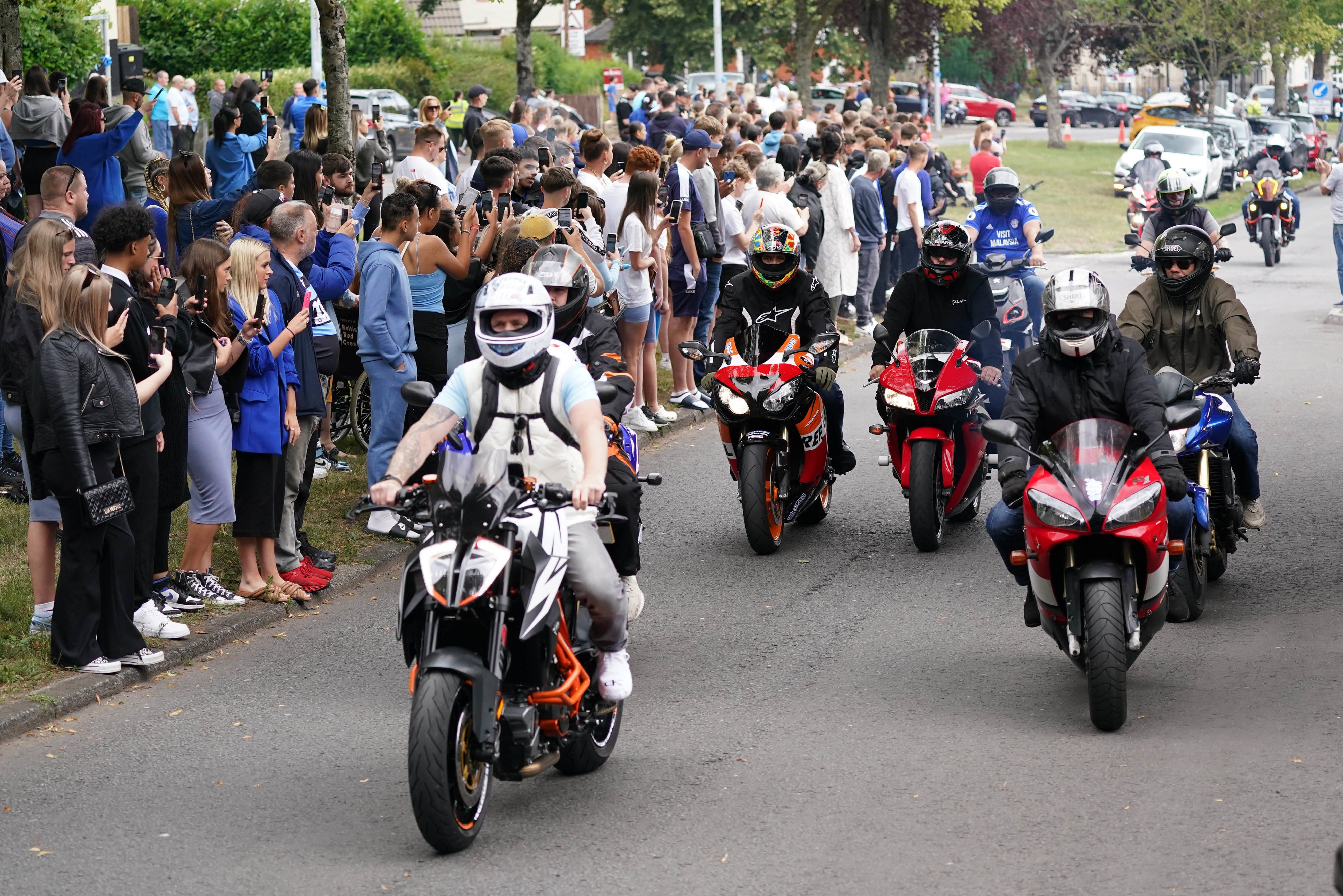 Motorbikes follow the funeral cortege of Kyrees Sullivan and Harvey Evans as it arrives at the Church of the Resurrection in Ely, Cardiff