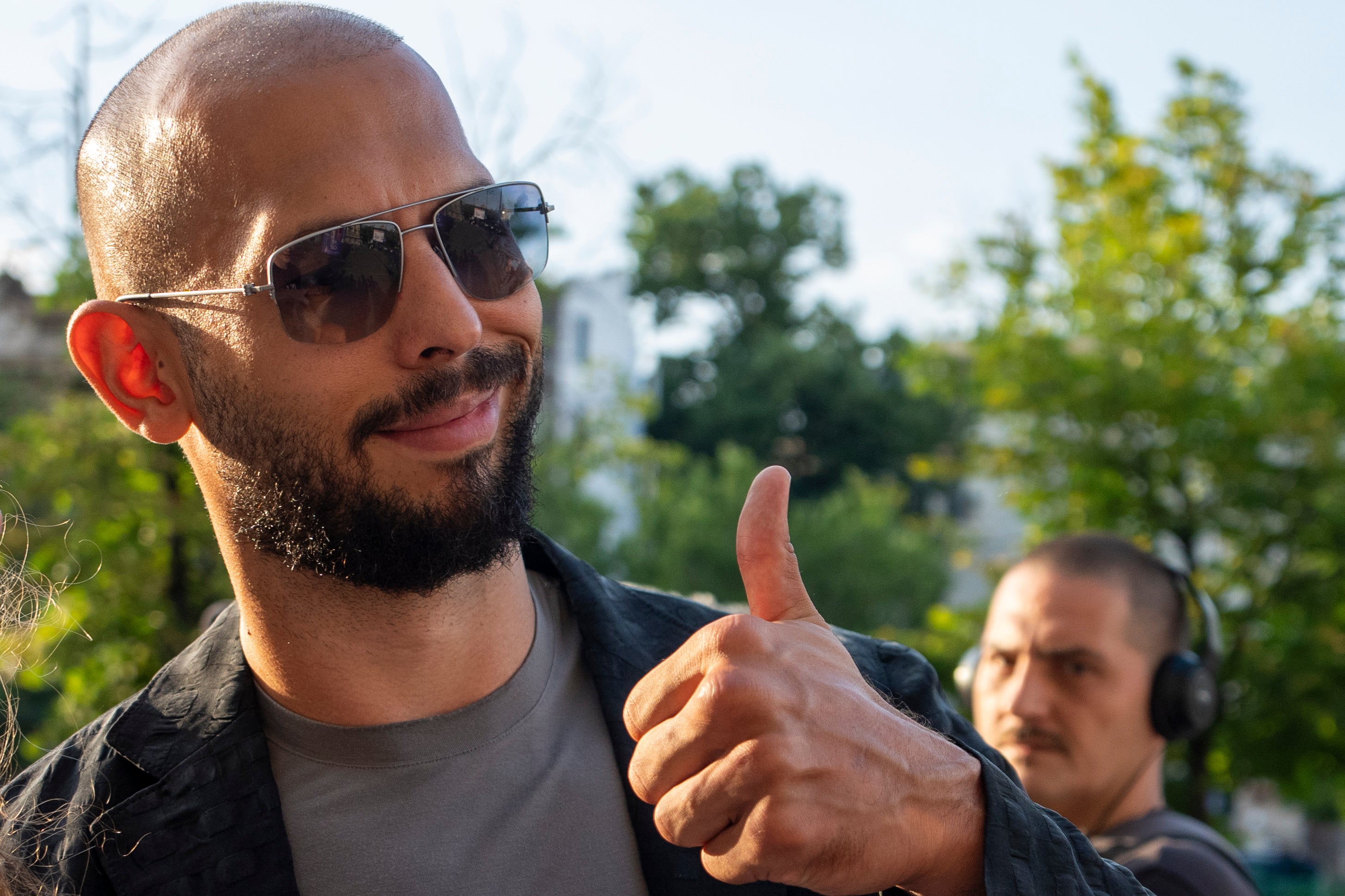 Andrew Tate gives a thumbs up upon exiting the Court of Appeal in Bucharest, Romania