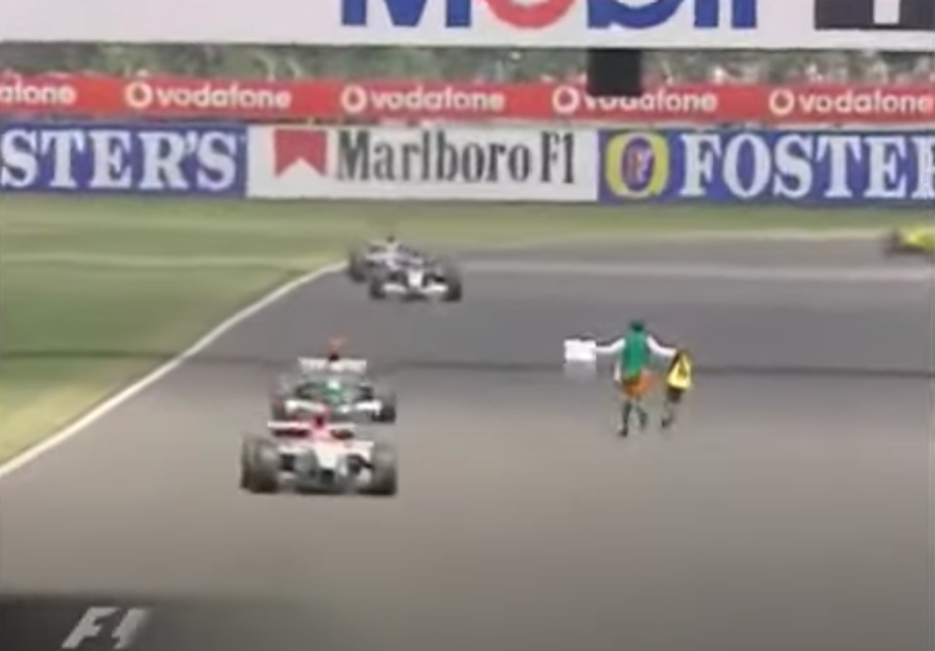Irish priest Neil Horan runs into the path of F1 cars at the 2003 British Grand Prix