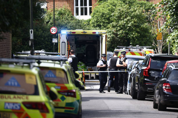 Police officers stand guard next to an ambulance behind a cordon following a car collision at the private Study Prep girls’ school in Wimbledon, southwest London, on 6 July 2023