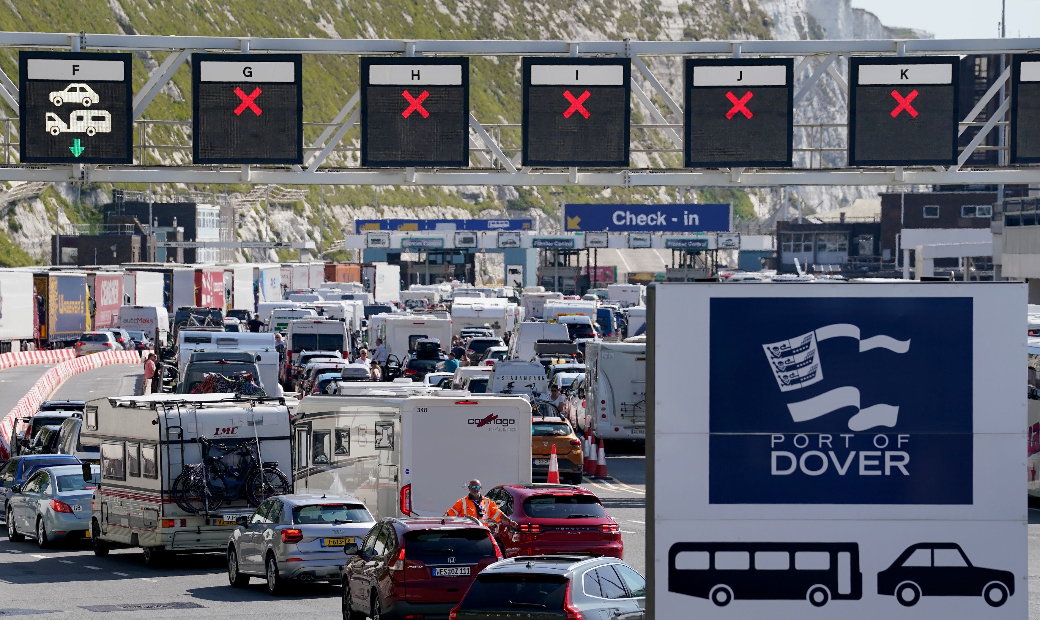 Vehicles queue for ferries at the Port of Dover, Kent, where passengers are facing up to a two-hour wait for checks by French border officials