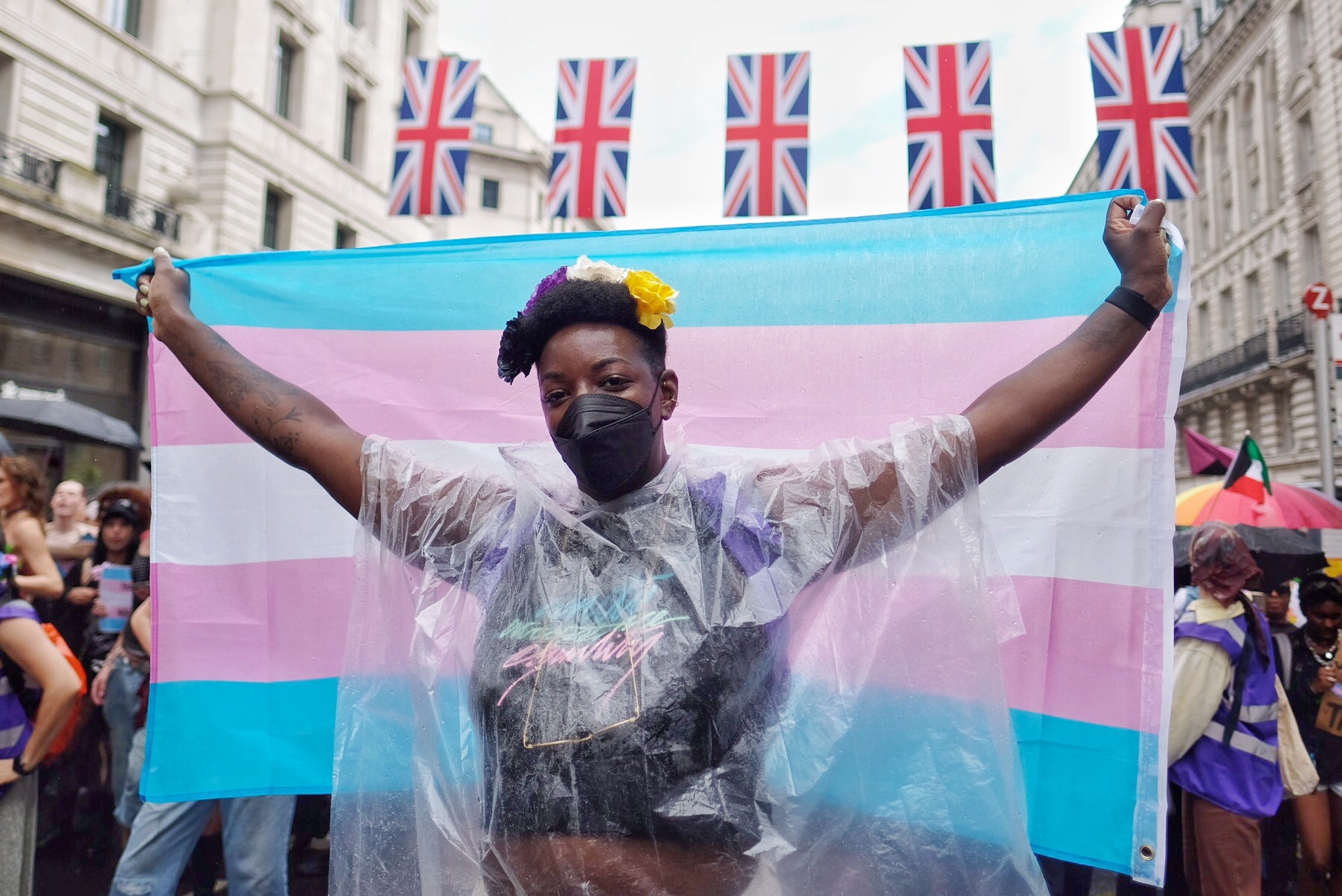 A marcher waves a trans flag in central London