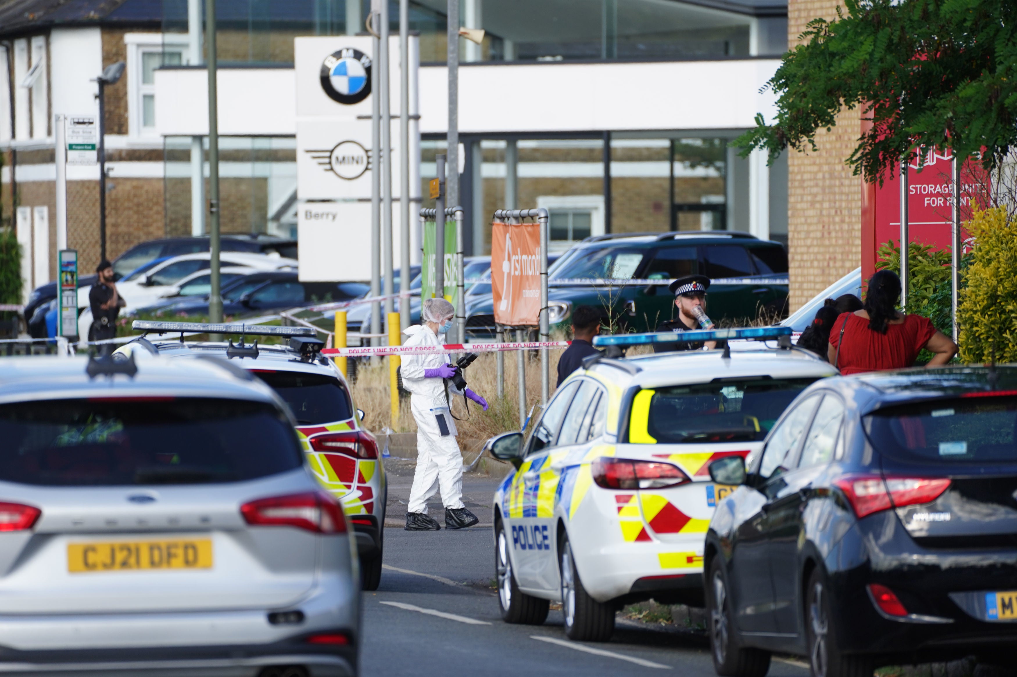 A forensics photographer on Portsmouth Road in Long Ditton