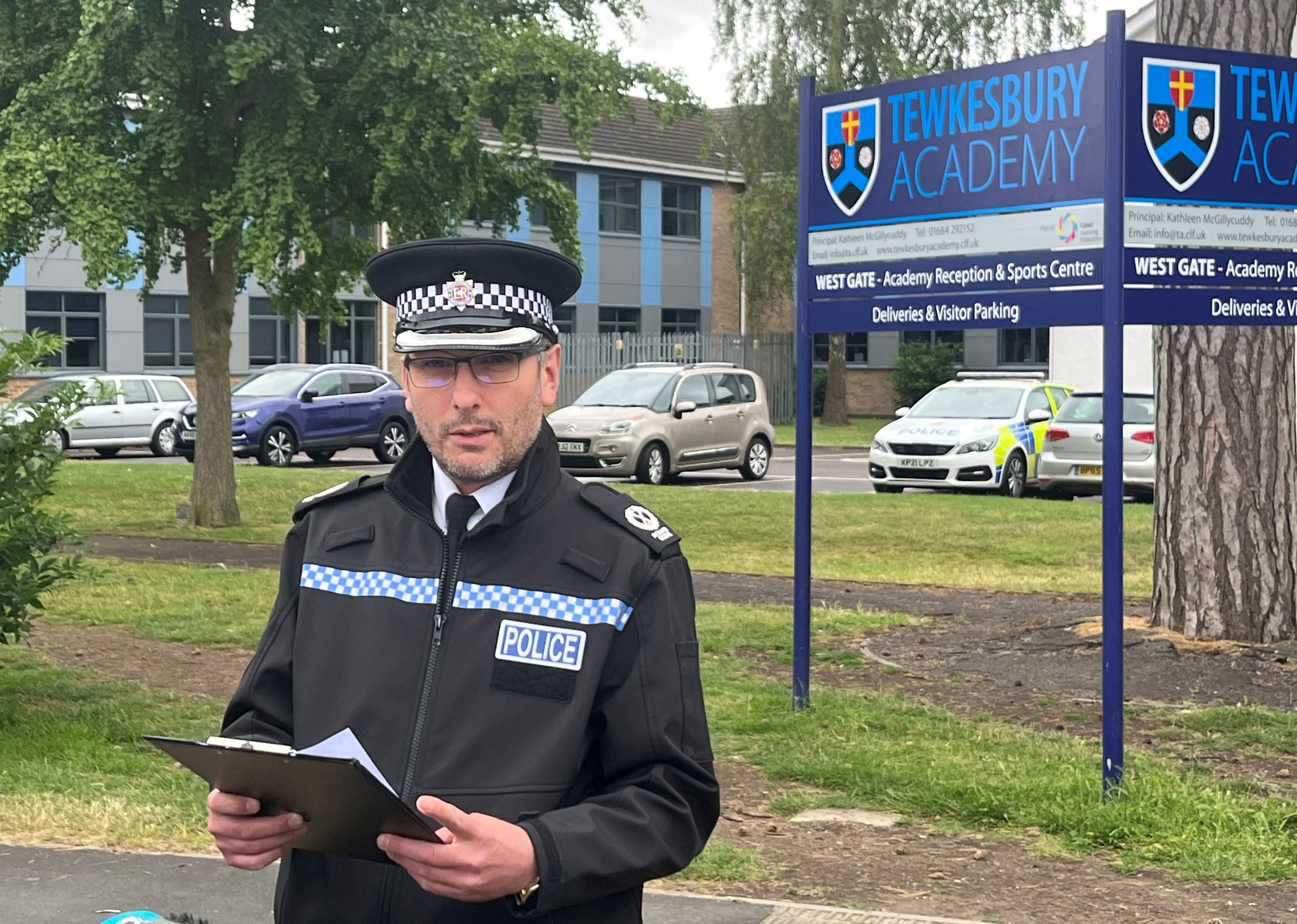 Assistant Chief Constable Richard Ocone, of Gloucestershire Police, reads a statement to reporters outside Tewkesbury Academy