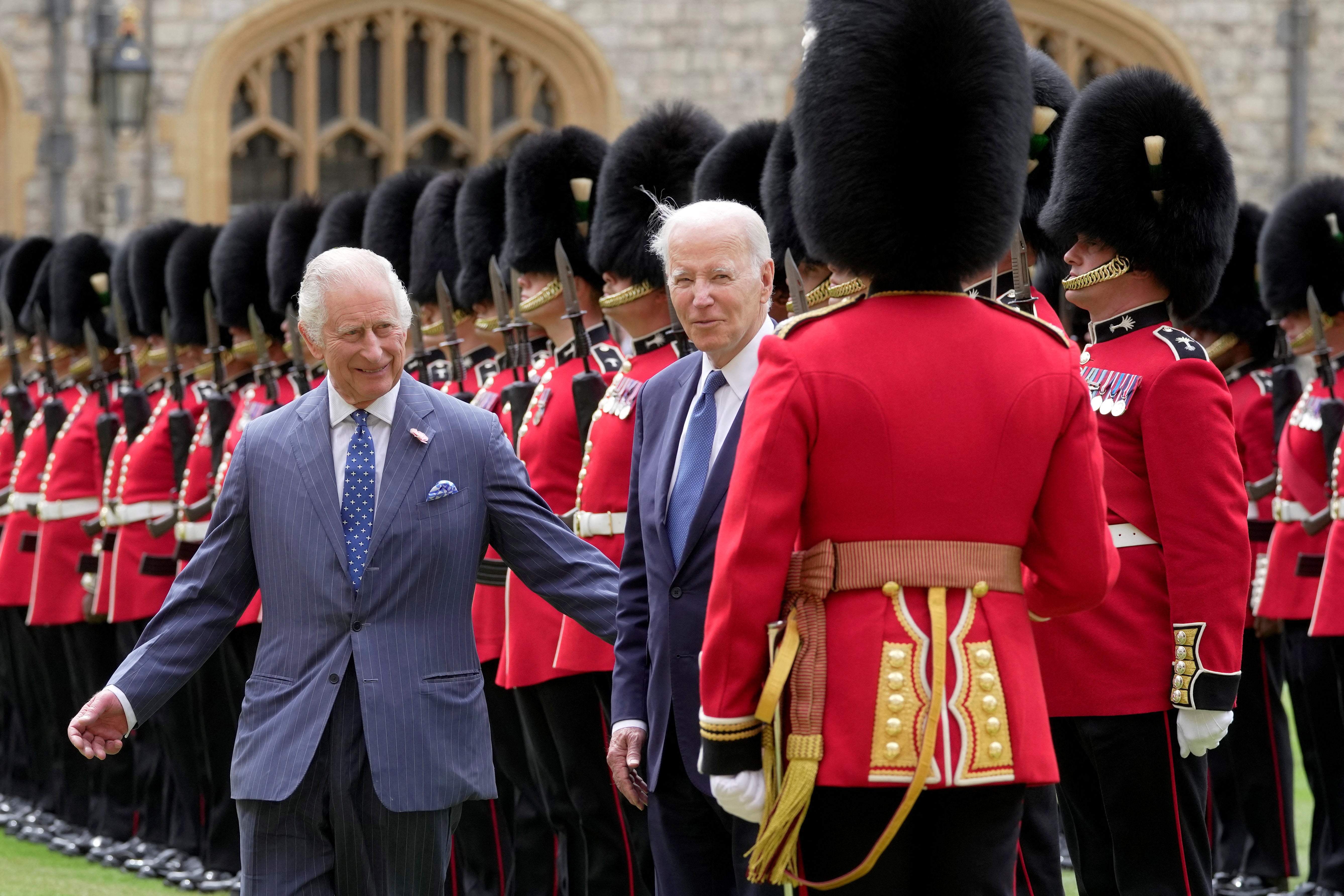 King Charles appears keen to lead President Biden away while the US leader chatted with a guardsman