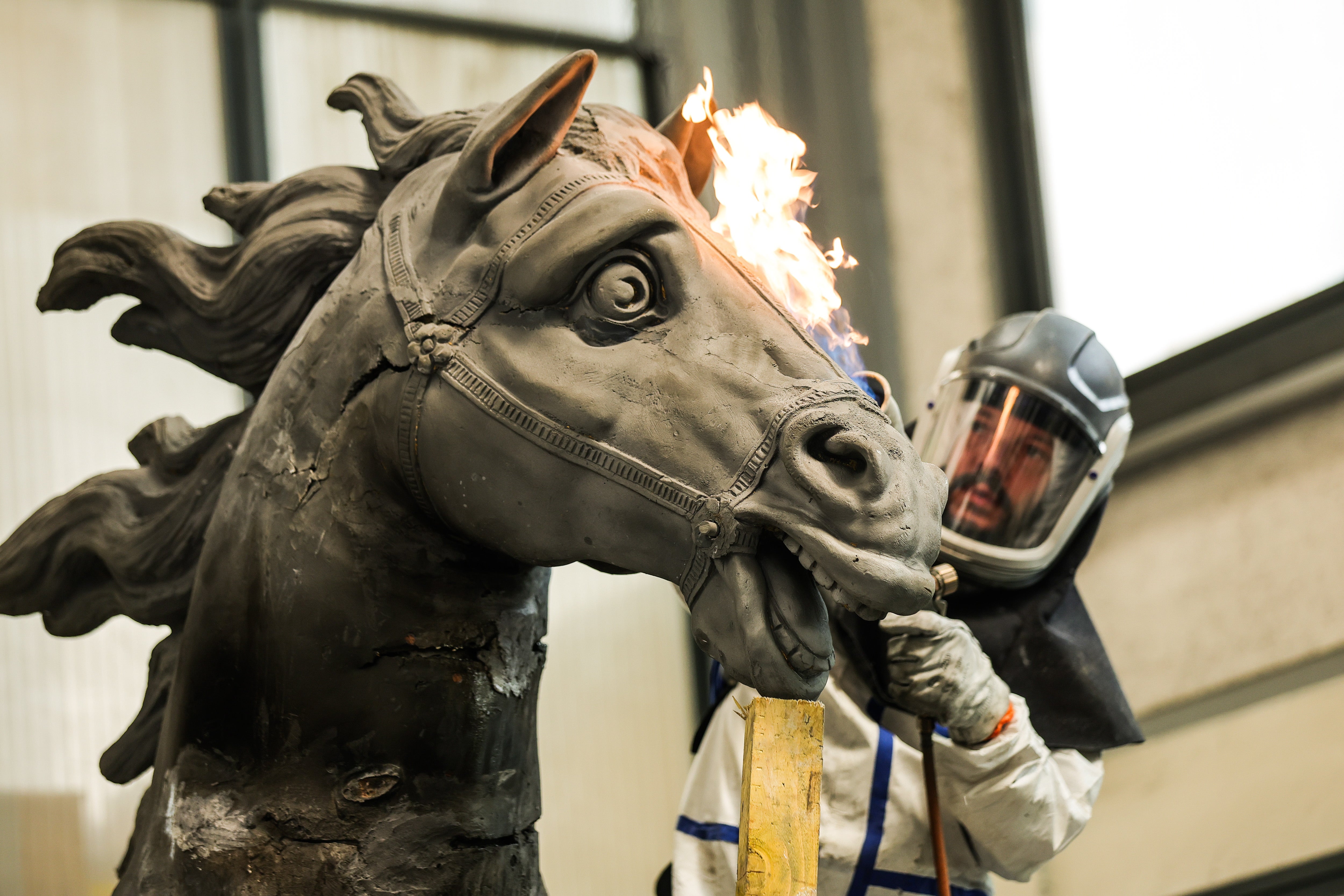 A boilermaker carries out restoration works on a horse sculpture of the fountain ‘Apollo on his Chariot’ during a press visit of the restoration process at the Coubertin Foundation in Saint Remy les Chevreuses, a Paris suburb, France, 10 July 2023. The fountain had not been restored for almost 100 years. Teams of artisans from various workshops of the Coubertin Foundation are finalizing the details for its reinstallation in the Gardens of Versailles in 2024