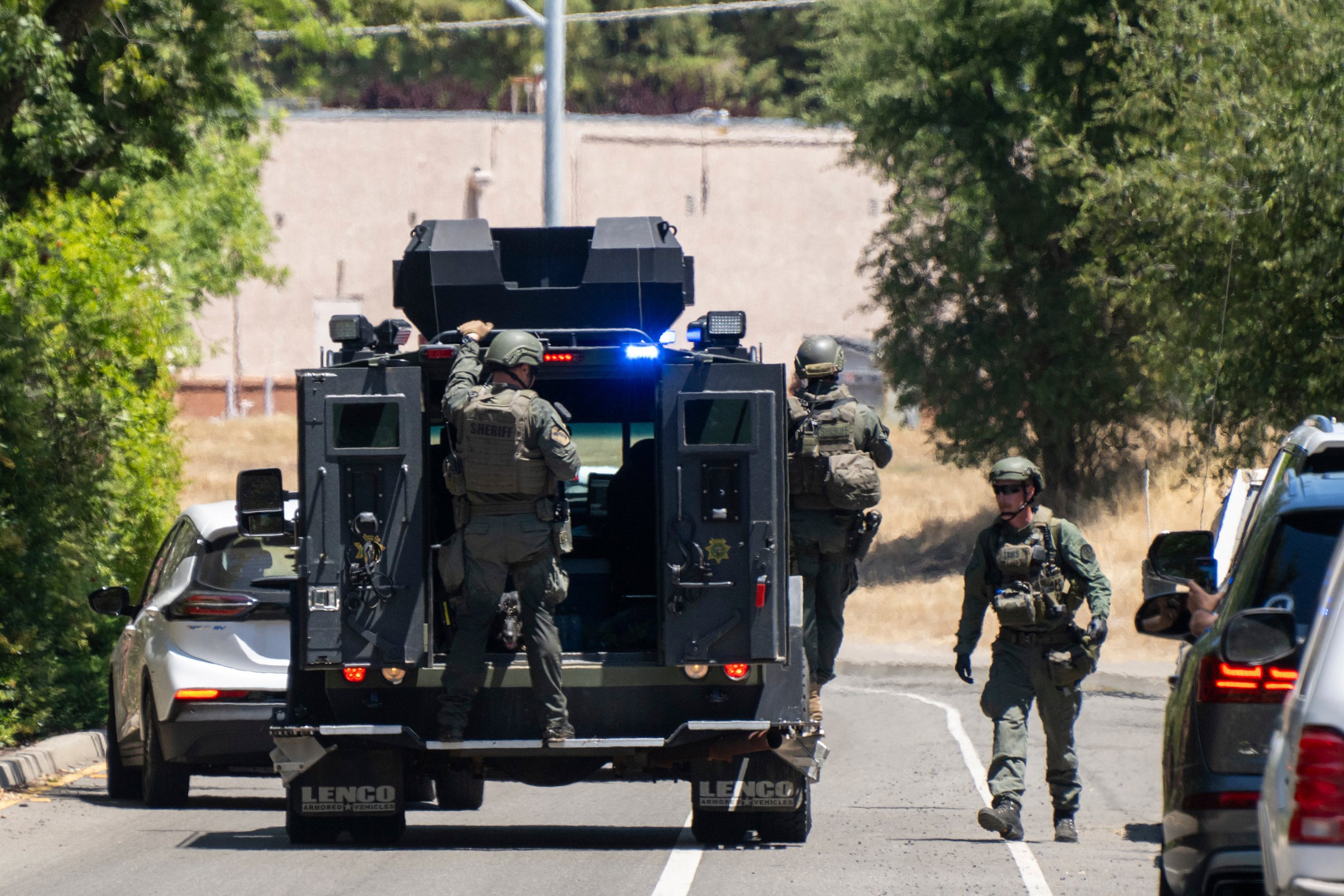 Police officers leave Zion Court after fugitive Eric Abril was captured on Monday