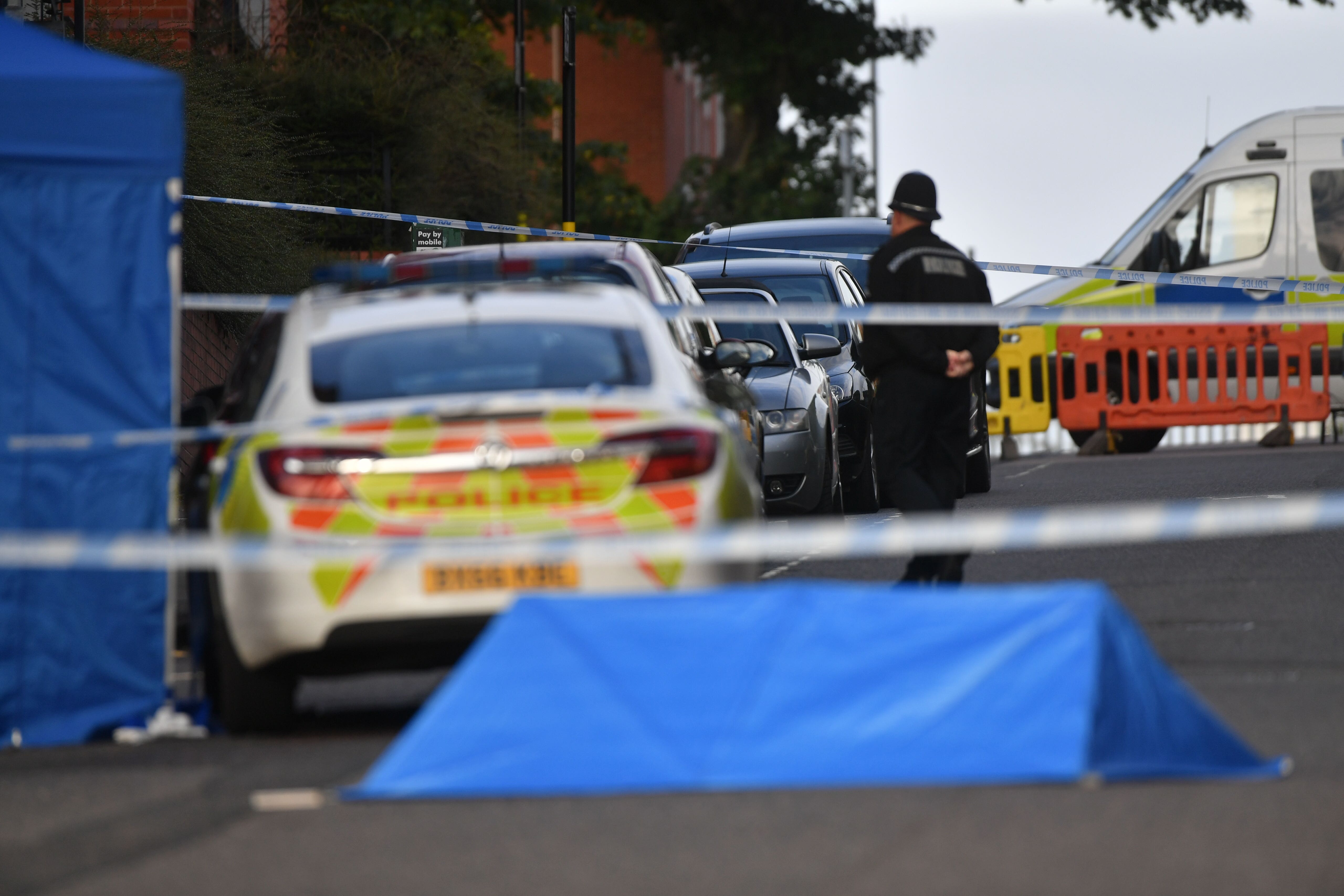 A police officer at a cordon in Irving Street in Birmingham after a number of people were stabbed in the city centre (PA)