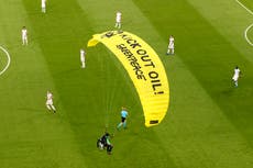 Greenpeace activists fined for crash-landing a parachute in stadium before Germany-France match