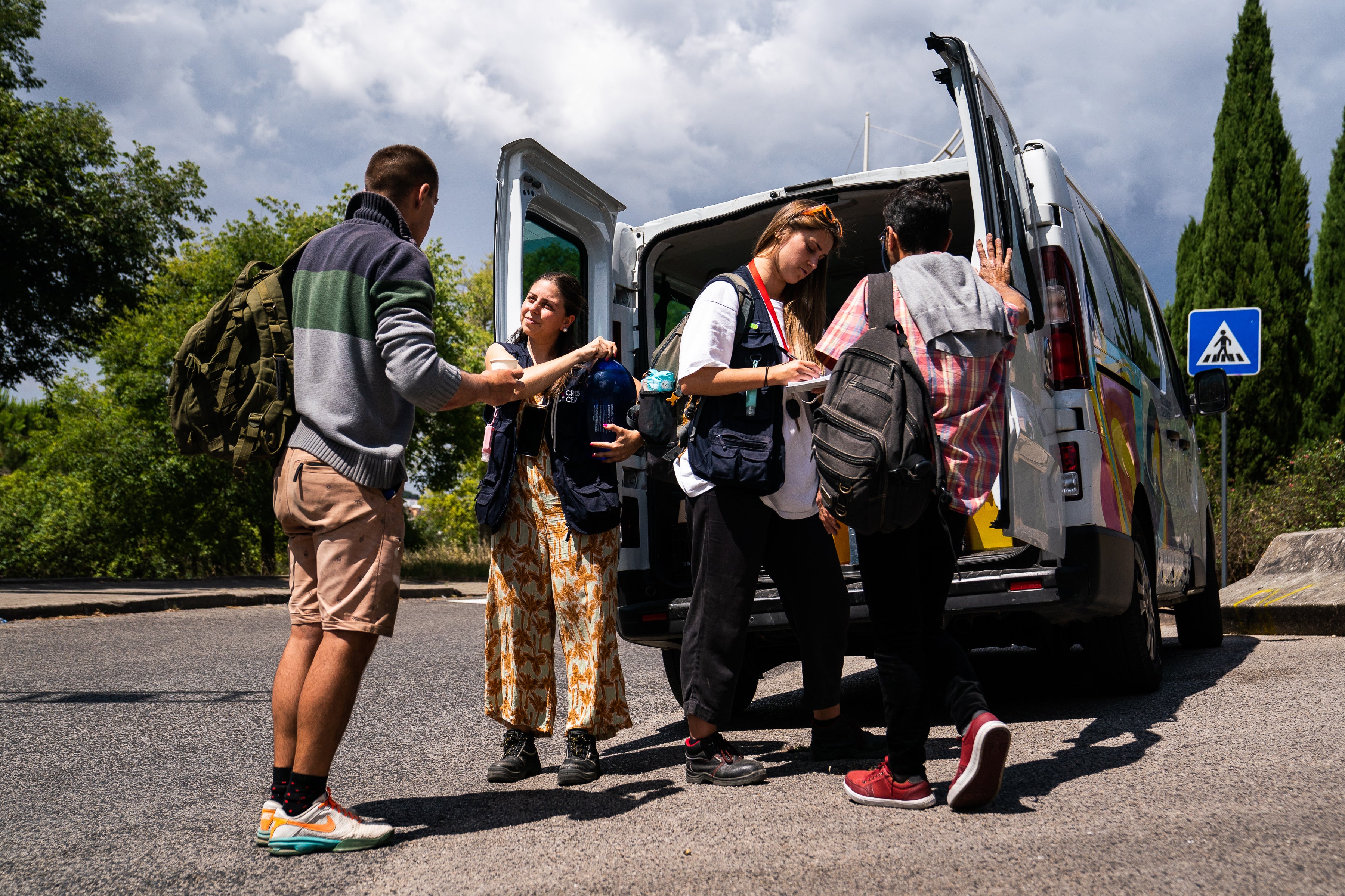 Mariana Gomes (left) and Antonia Cabrita of the Crescer organisation’s outreach team speak with people during a daily check in Lisbon