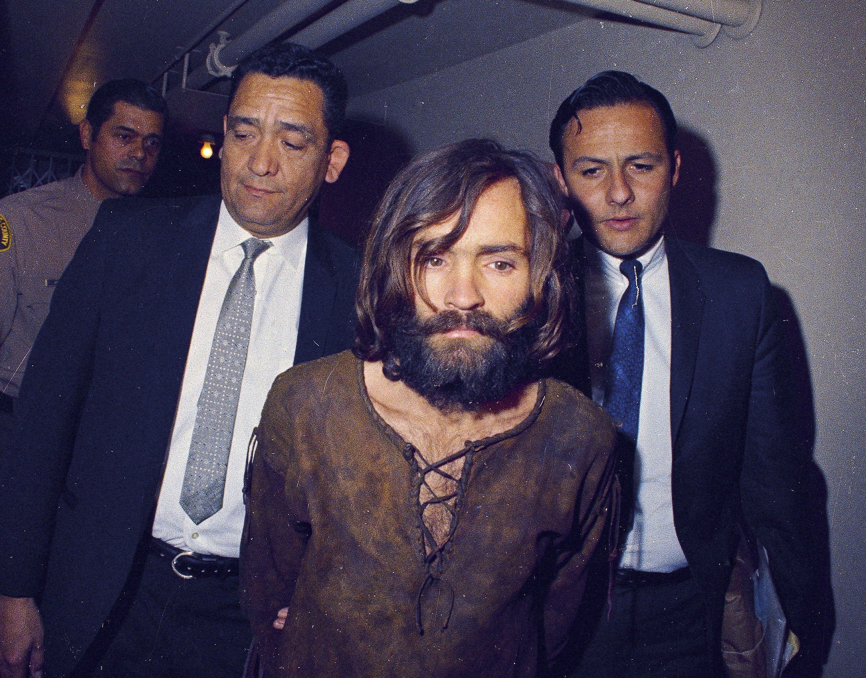 Charles Manson is escorted to his arraignment on conspiracy-murder charges in connection with the Sharon Tate murder case in Los Angeles in 1969