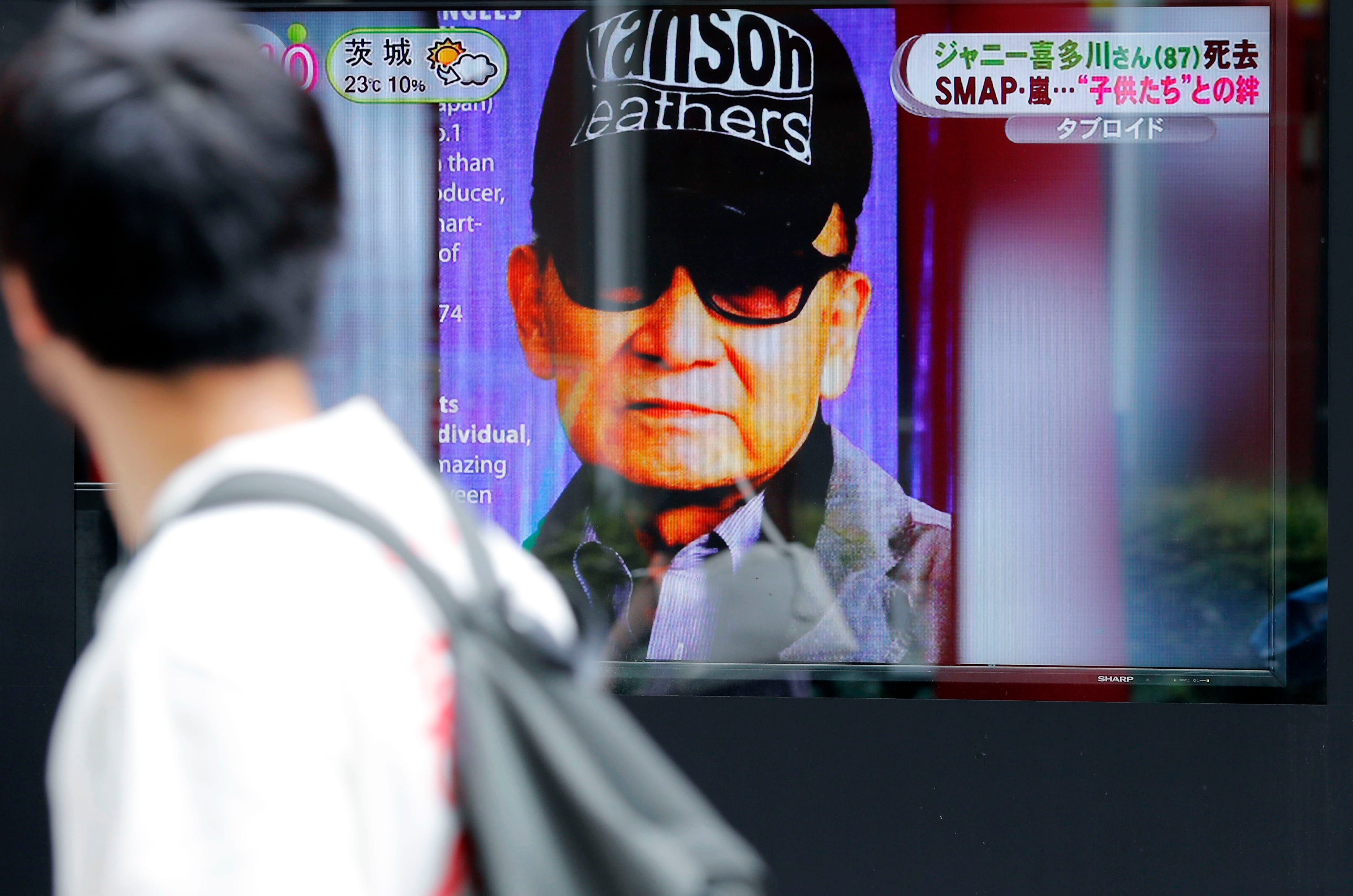 File photo: A passerby watches a TV news reporting Johnny Kitagawa’s passing away in Tokyo, on 10 July 2019