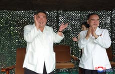 North Korea threatens US after record ICBM launch as pictures of delighted Kim Jong-un emerge