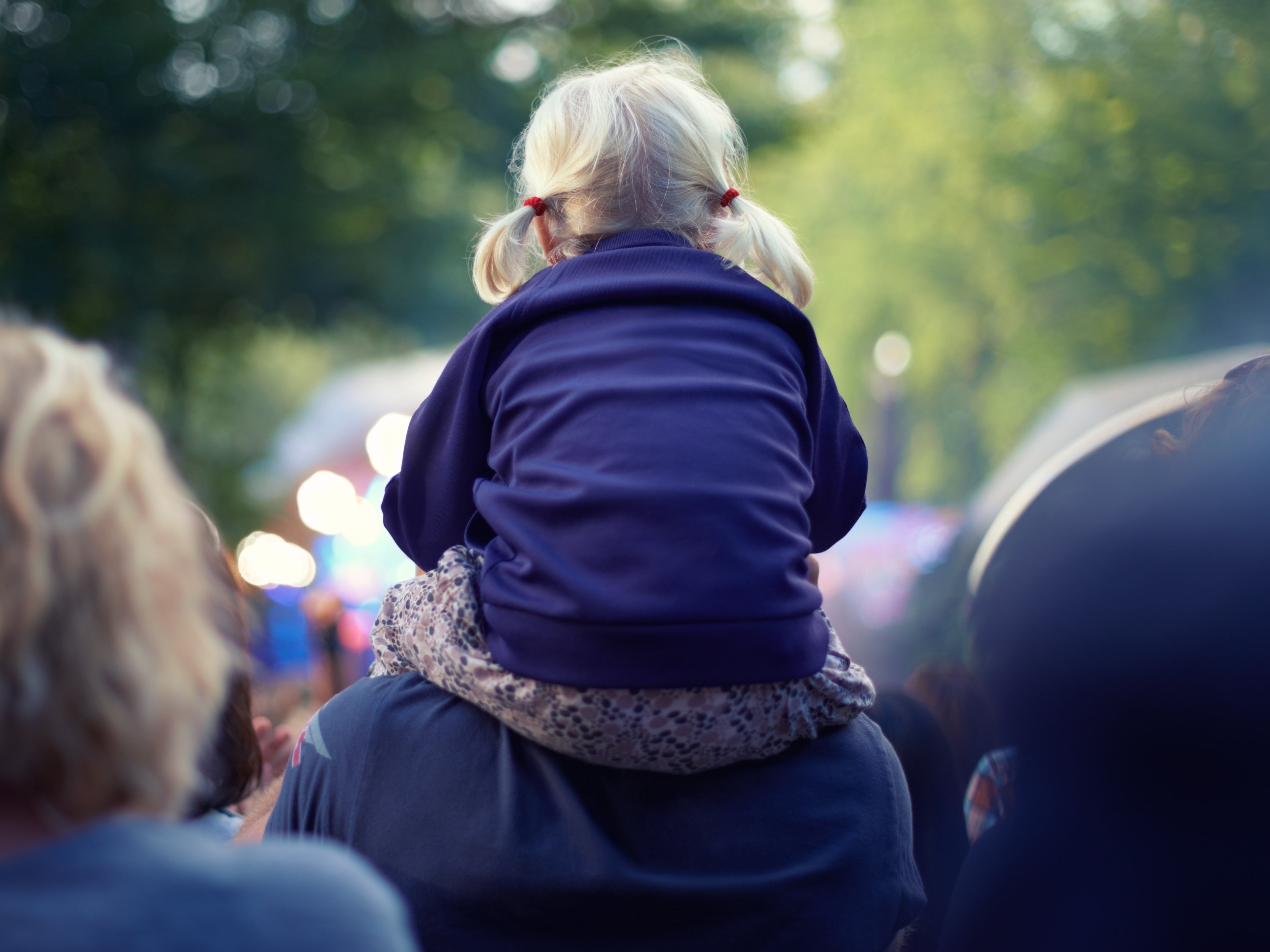 Best seat in the house: A little girl sits atop her dad’s shoulders at a music festival