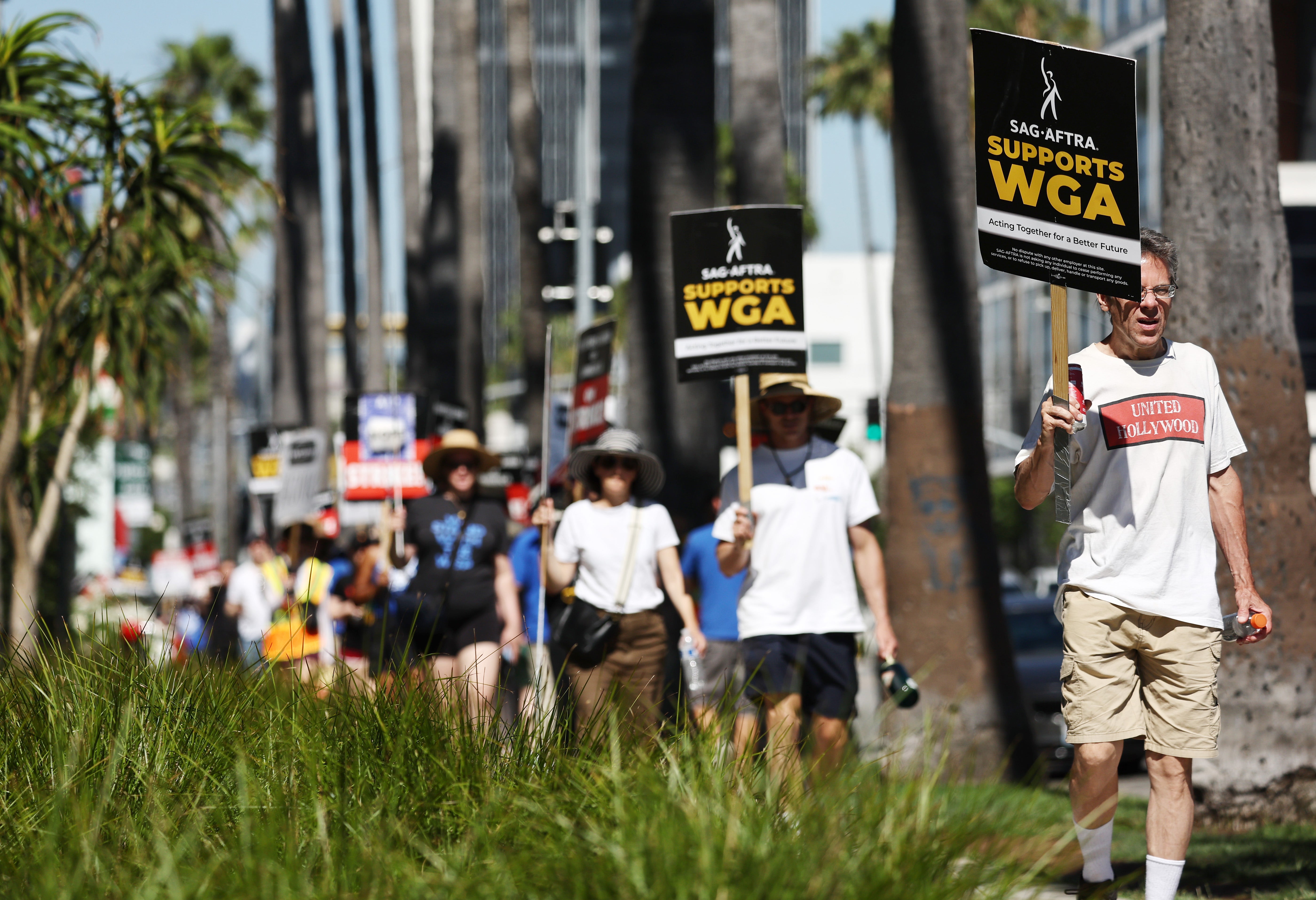 Striking SAG-AFTRA and WGA members on the picket lines as America faces its own wave of industrial action
