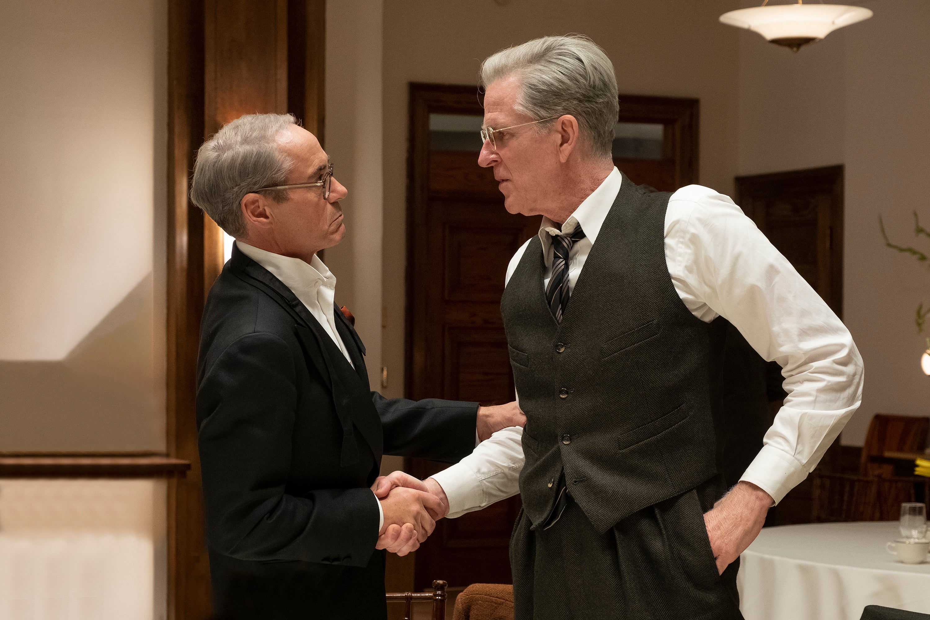 Robert Downey Jr as Lewis Strauss, left, and Matthew Modine as Vannevar Bush in a scene from ‘Oppenheimer’