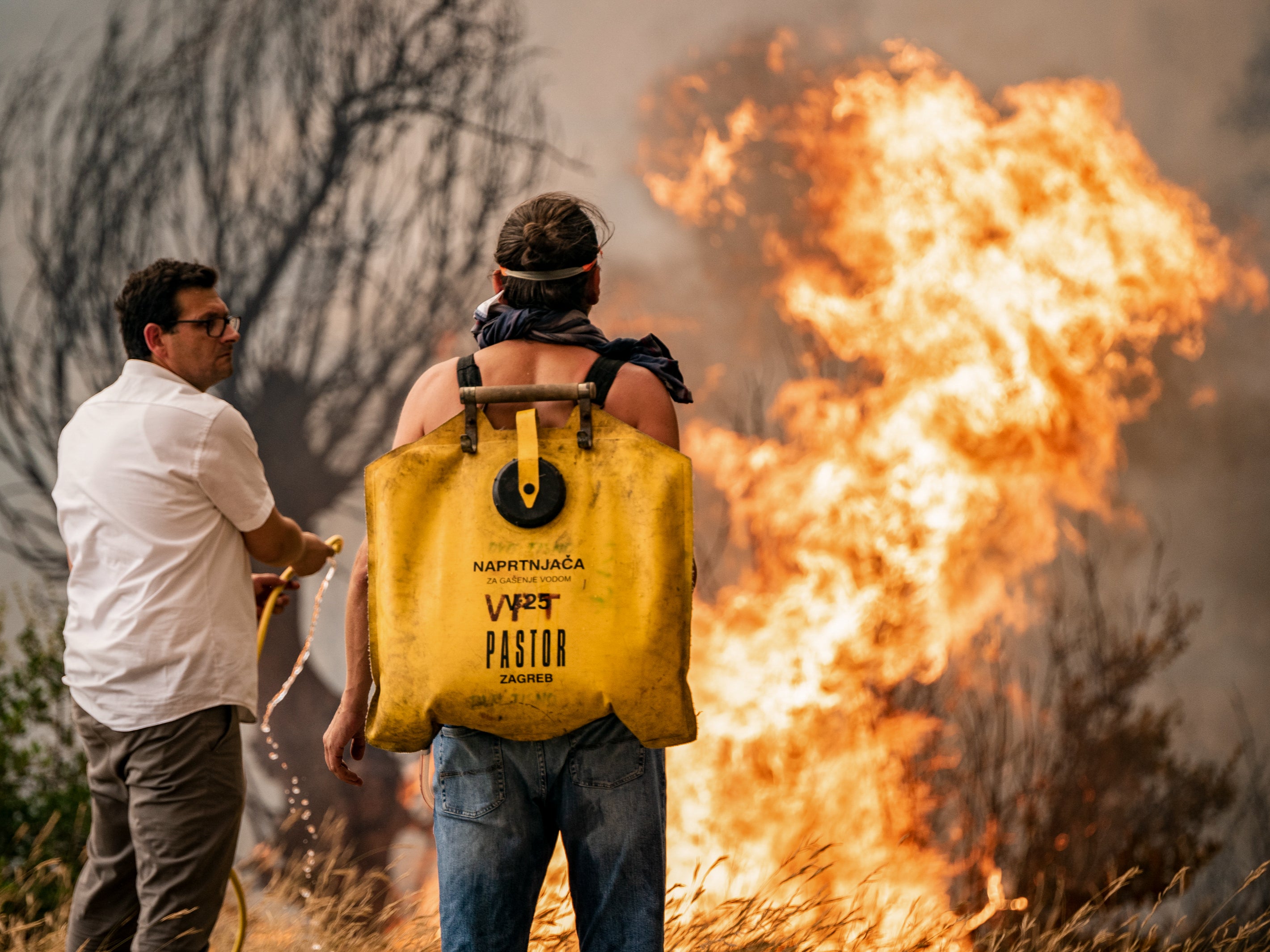 Volunteers try to put out the wildfire in Grebastica