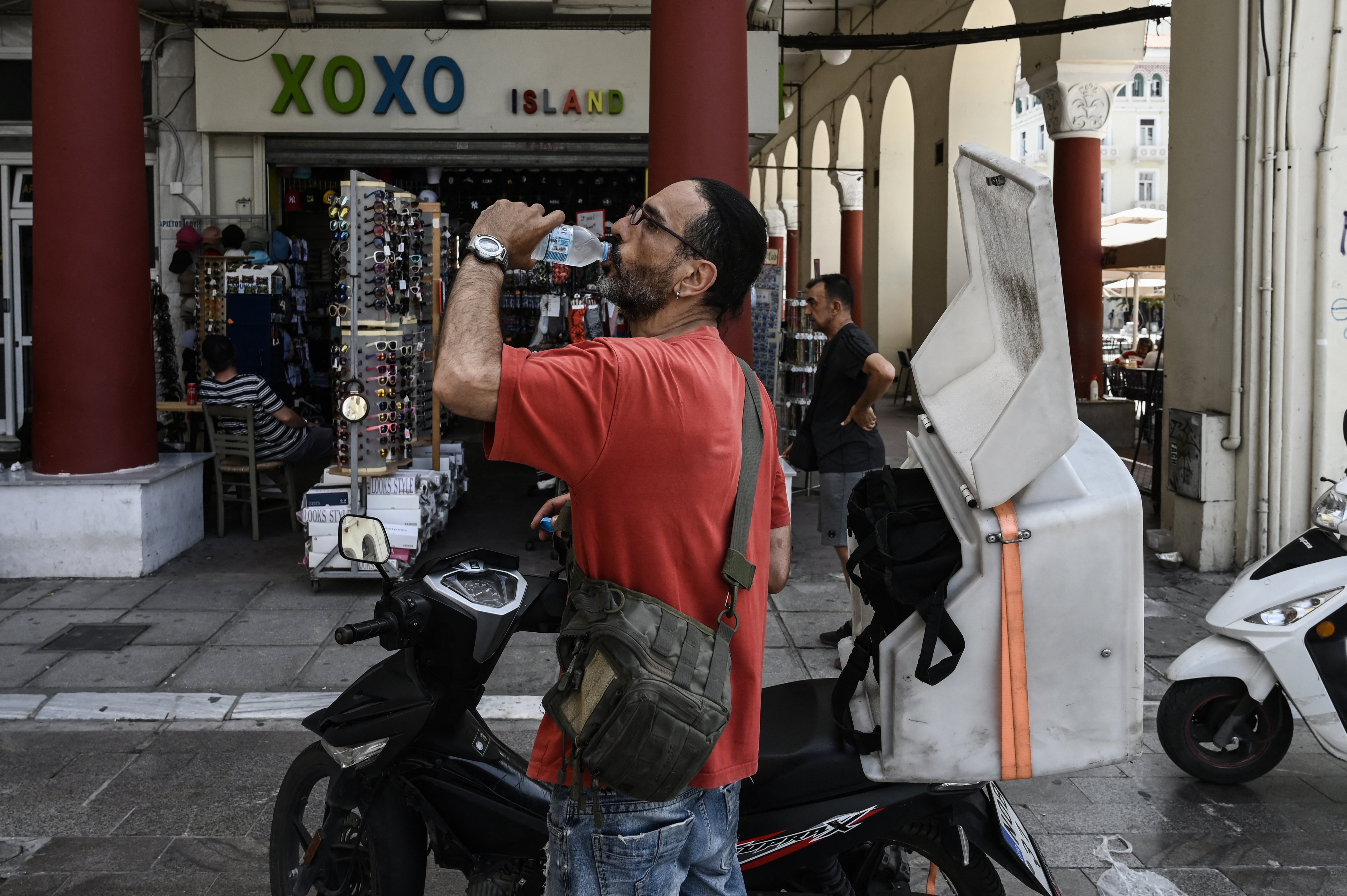 A delivery man drinks water in Thessaloniki