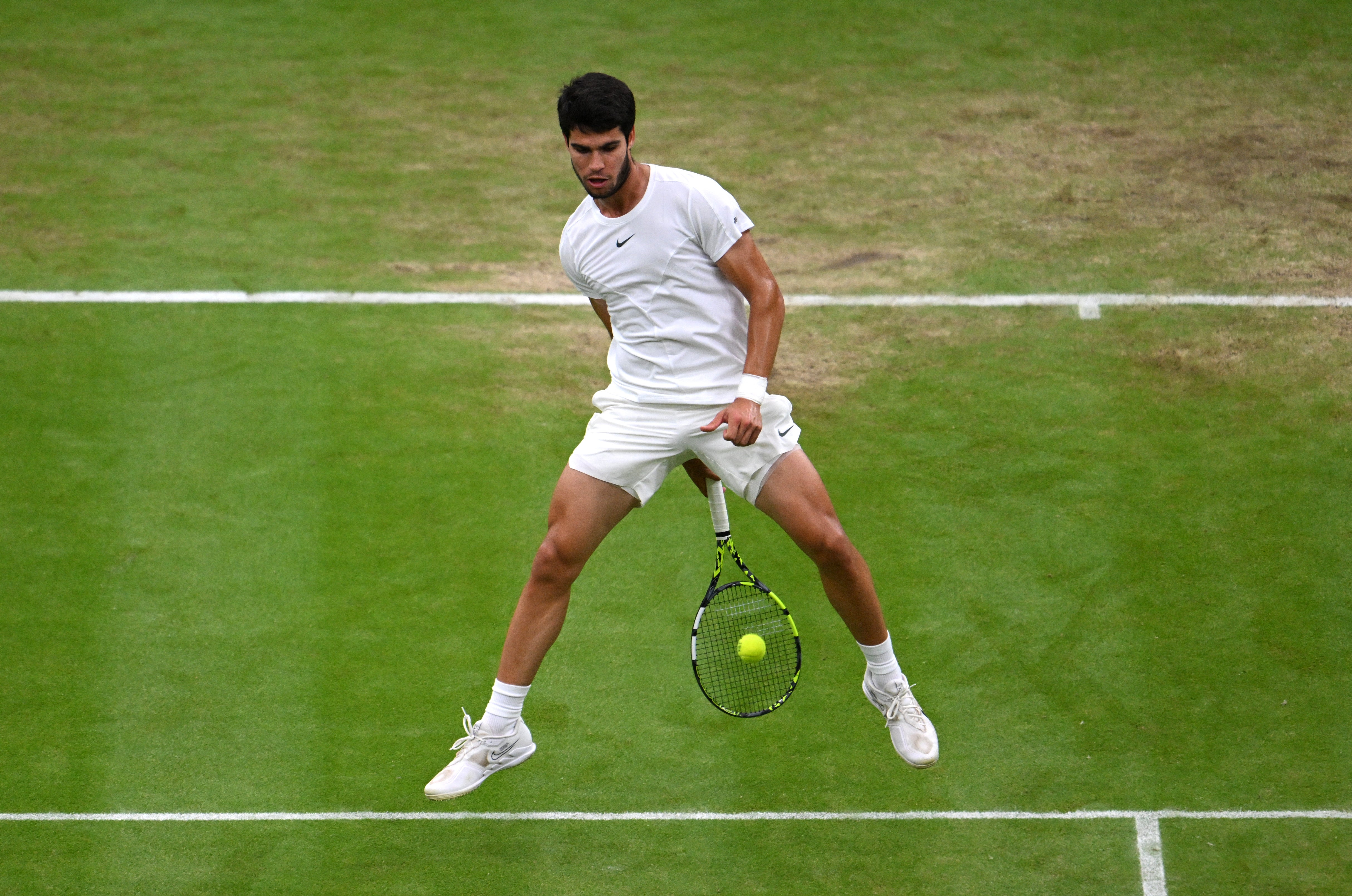 Alcaraz, closing in on victory, attempts a volleyed tweener