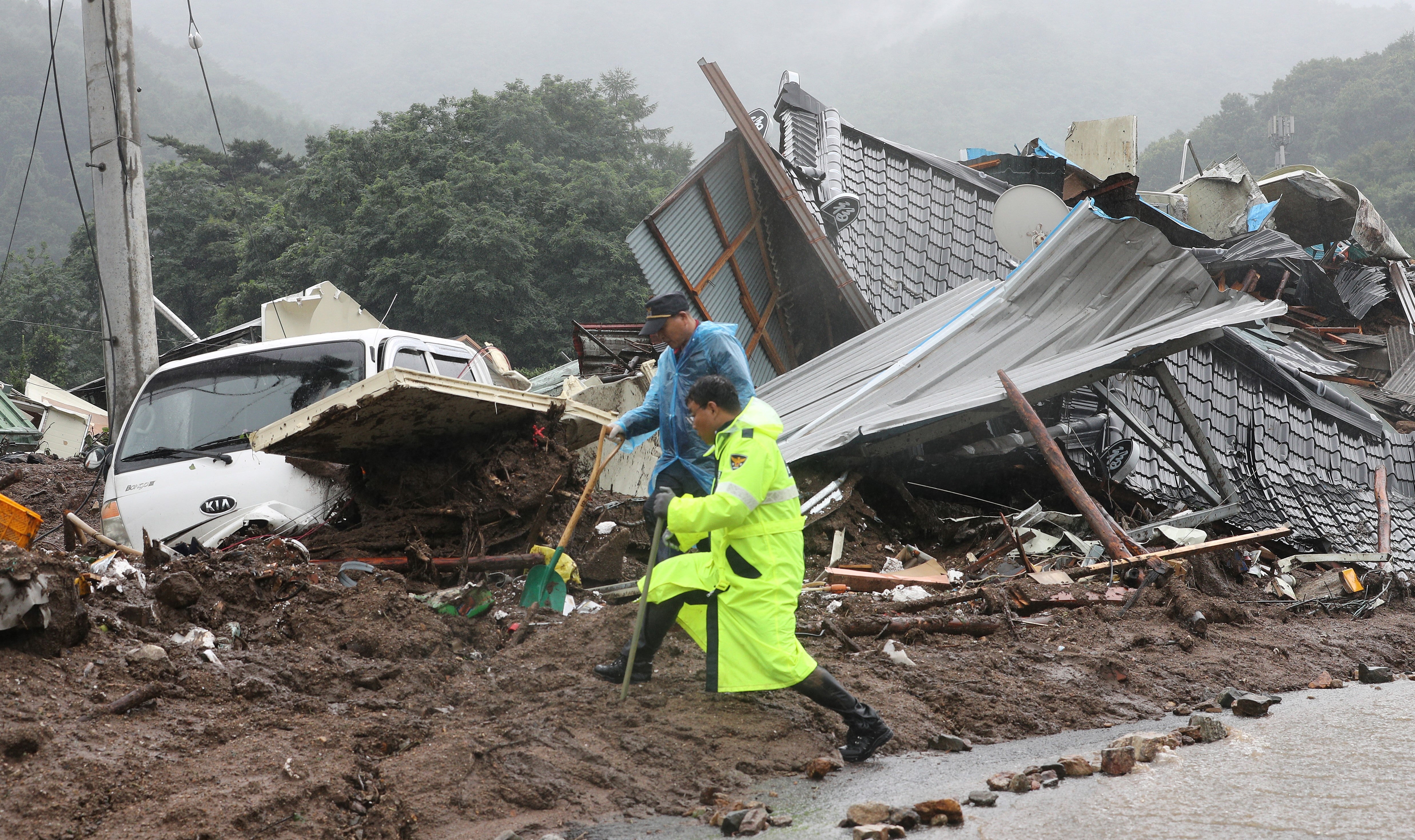 Over 20 dead and 10 missing as landslides, flood sweep homes in South Korea
