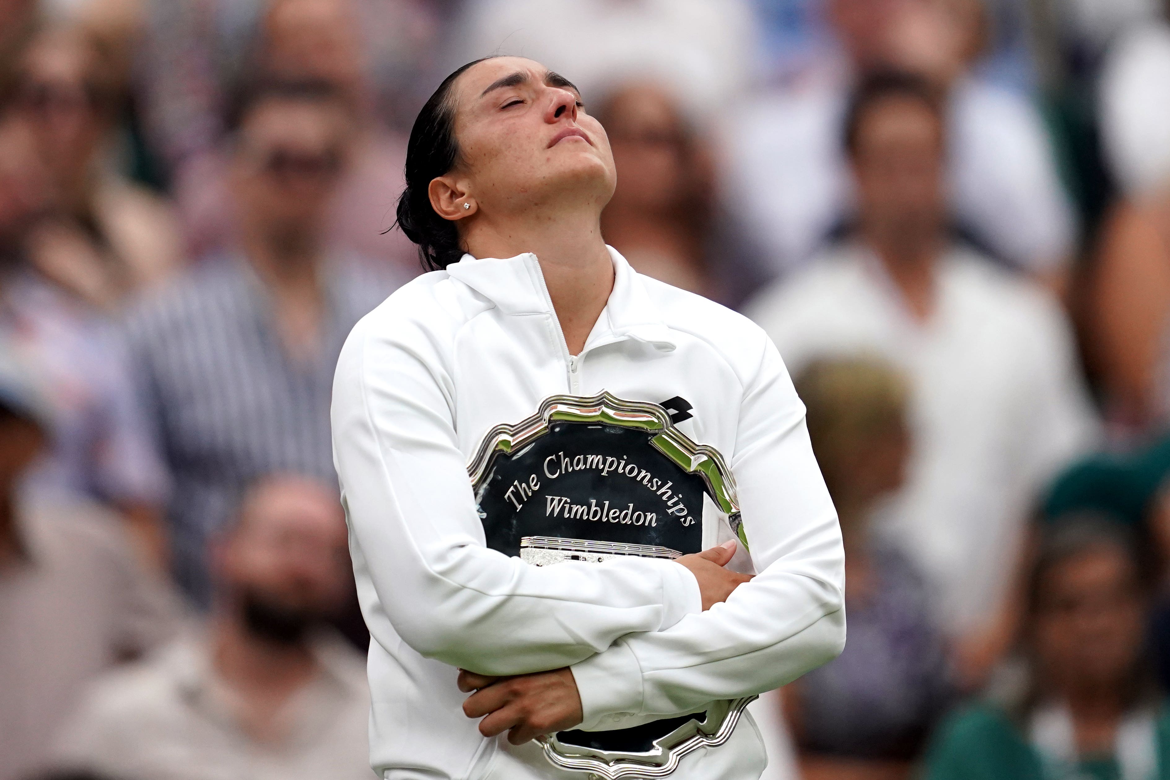 Ons Jabeur hugs the runners-up plate after her third grand slam final loss (Victoria Jones/PA)