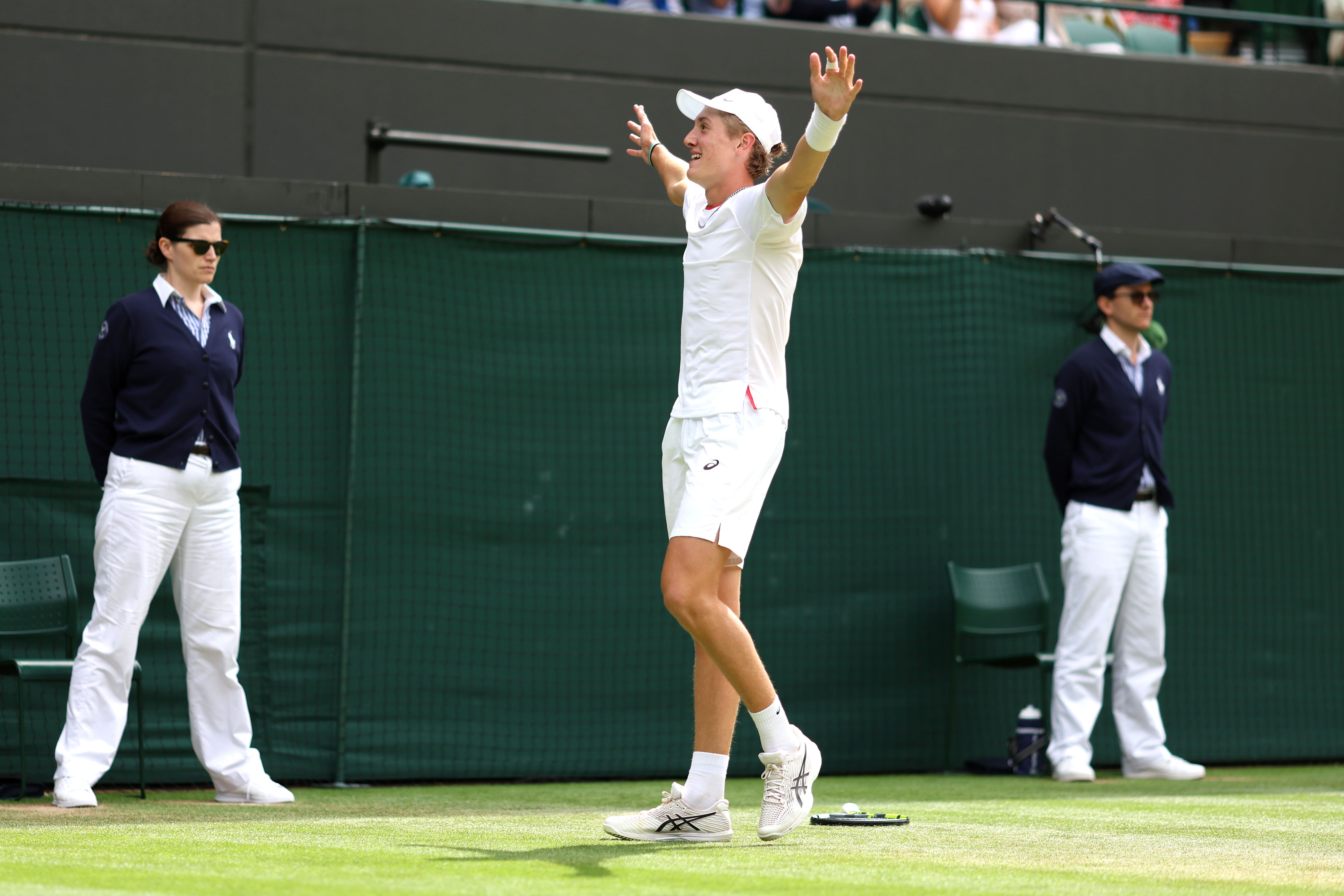 Henry Searle celebrates victory against Yaroslav Demin in the boys’ singles final (PA)