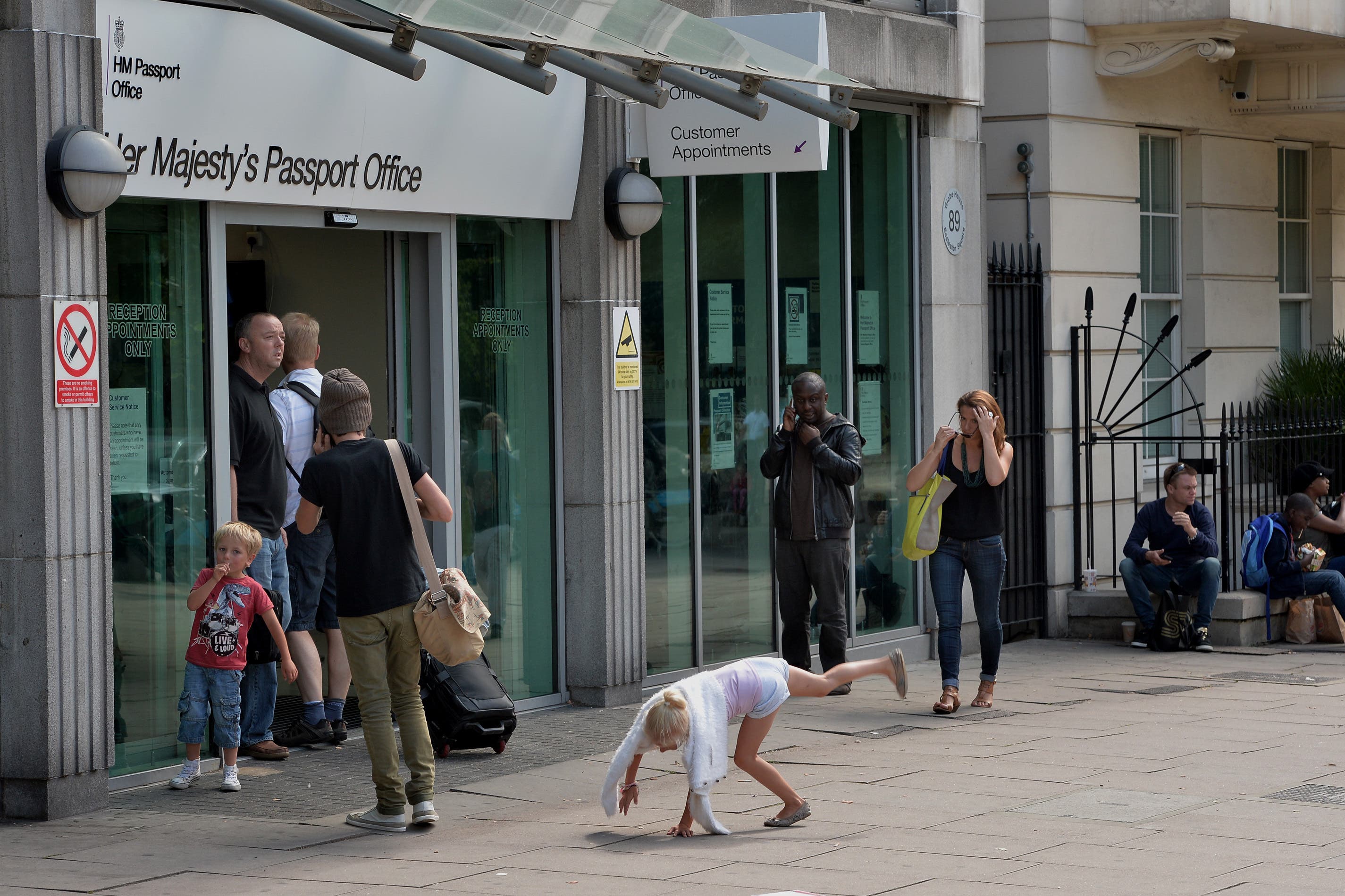 Collect an application form from a post office, fill it out and turn up with two photos at a passport office, such as the one in Victoria, London, for a pre-booked appointment