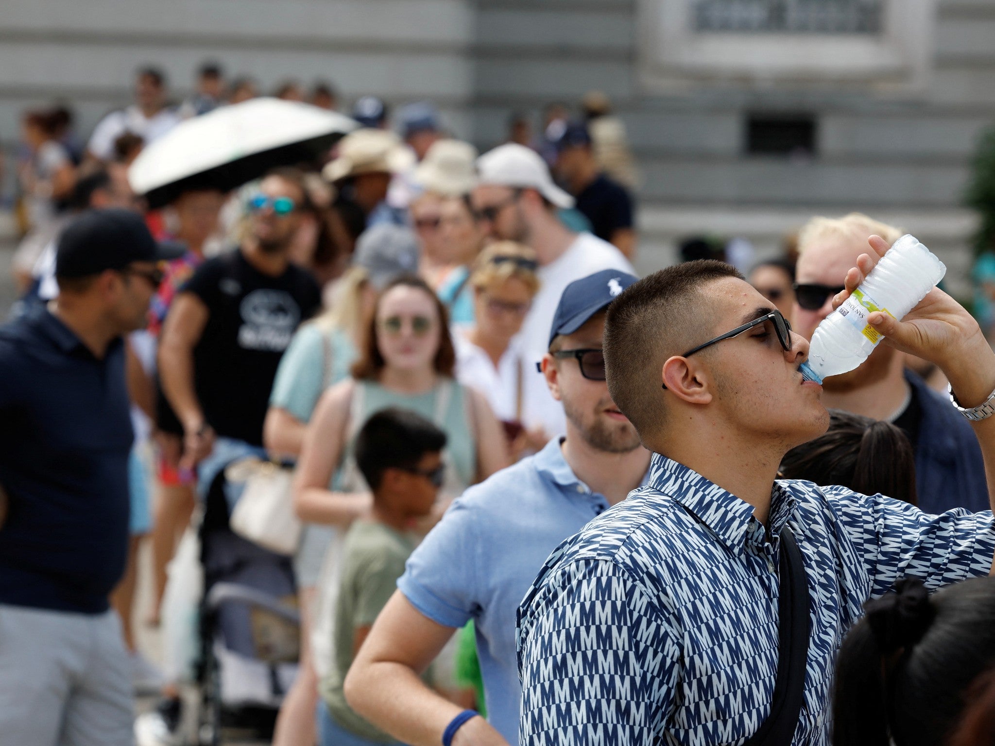 Tourists try to withstand the hot weather in Madrid as most of Spain is under alert for high to extreme heat