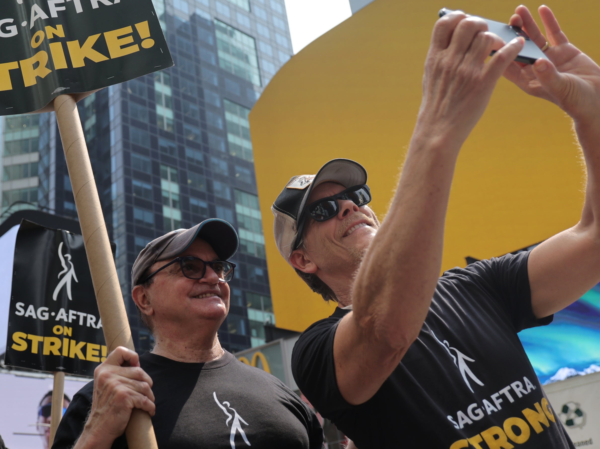 Kevin Bacon (R) and SAG-AFTRA members and supporters protest as the SAG-AFTRA Actors Union Strike continues in front of Paramount Studios at 1515 Broadway on July 17, 2023 in New York City.