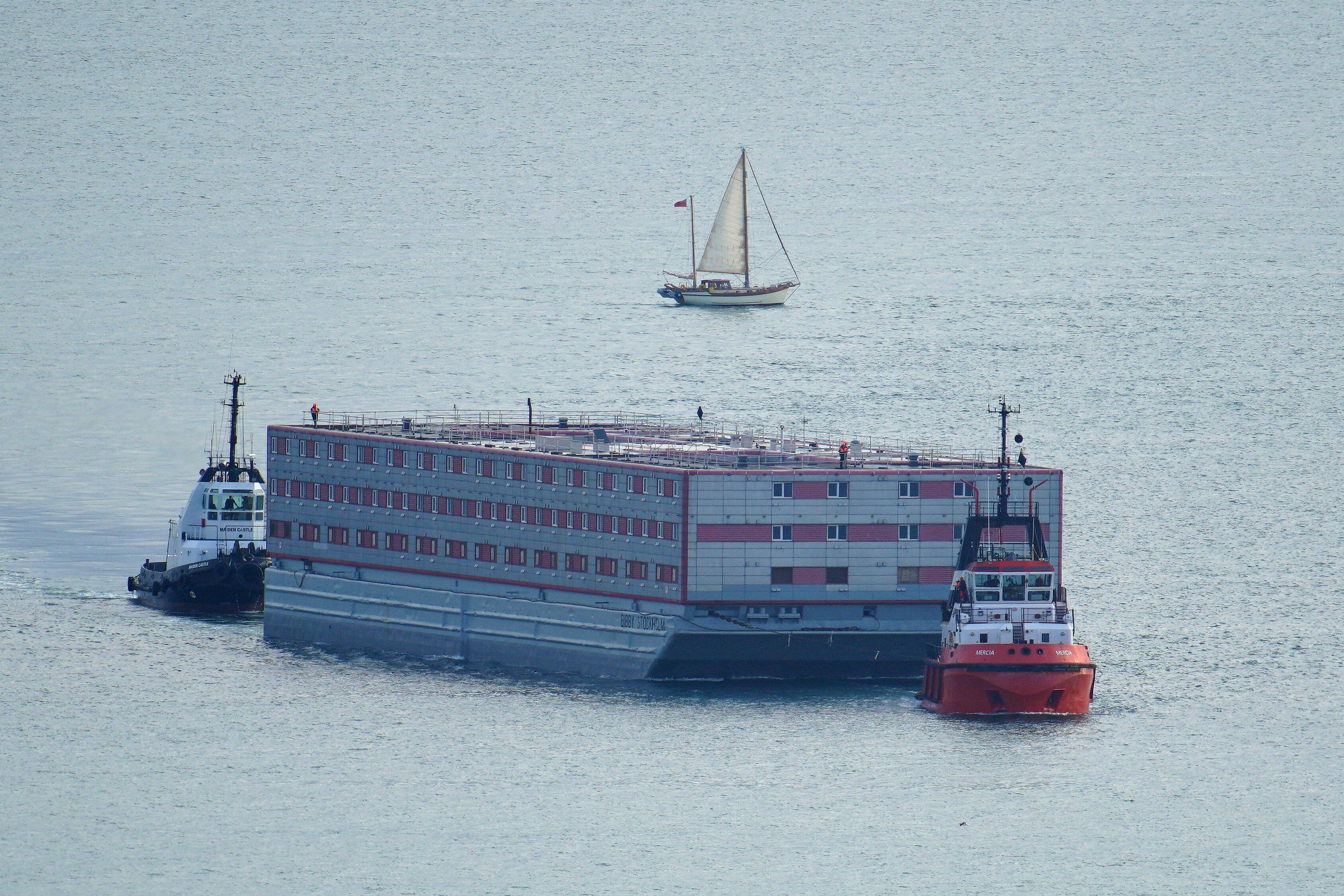 Tug boat Mercia pulls the Bibby Stockholm accommodation barge (Ben Birchall/PA)