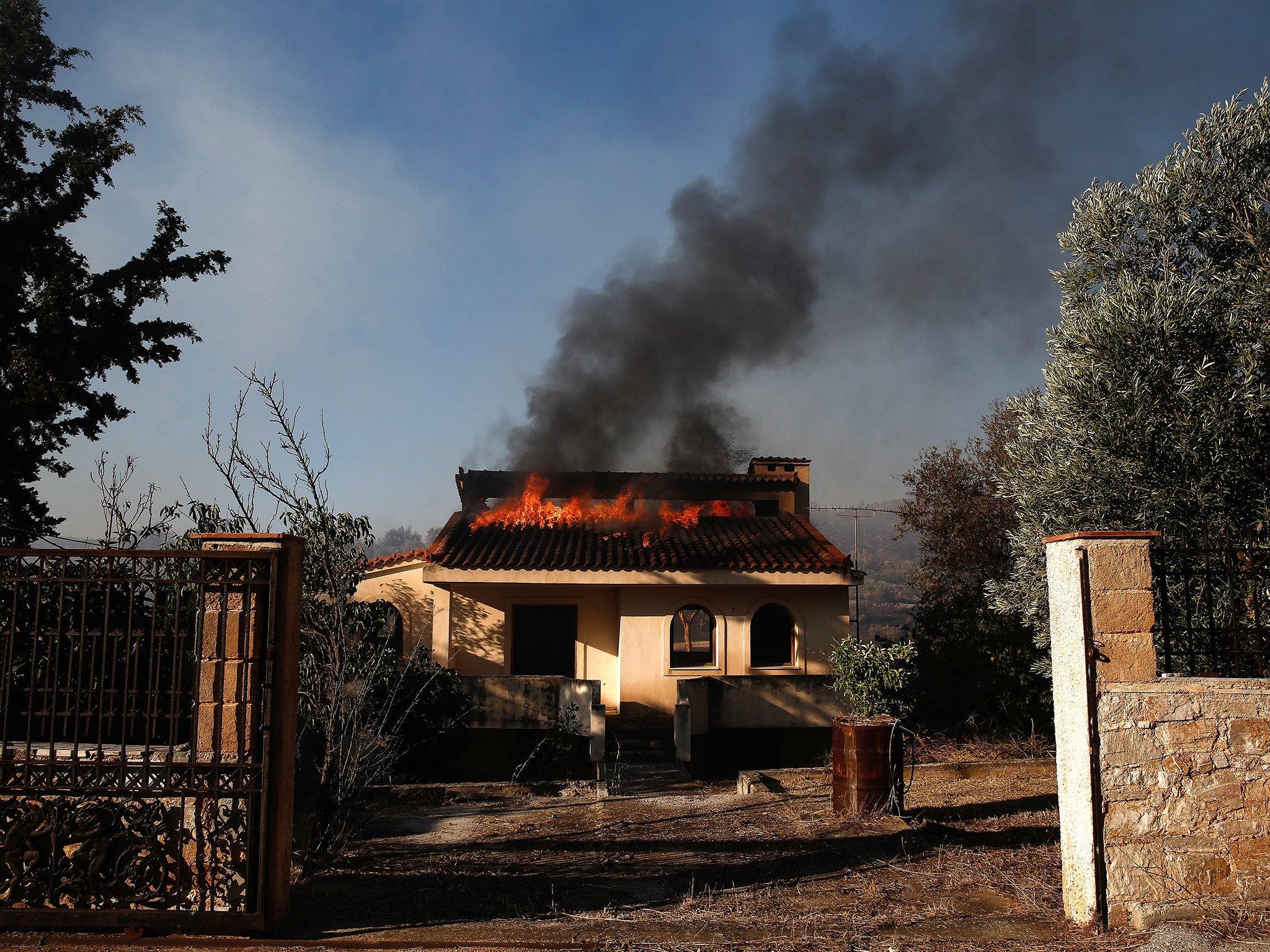 A house burns during a wildfire at Kalyvia area in Attica, Greece, 17 July 2023